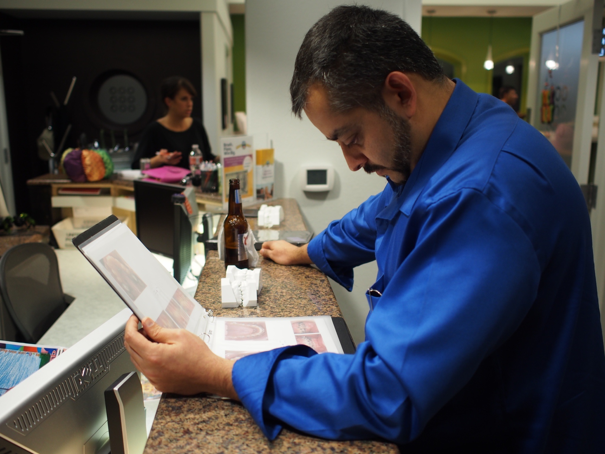 TOSC Guest Dr. Vishnu Raj looks over a TOSC notebook to see how they are prepared for the Annual Meetings.