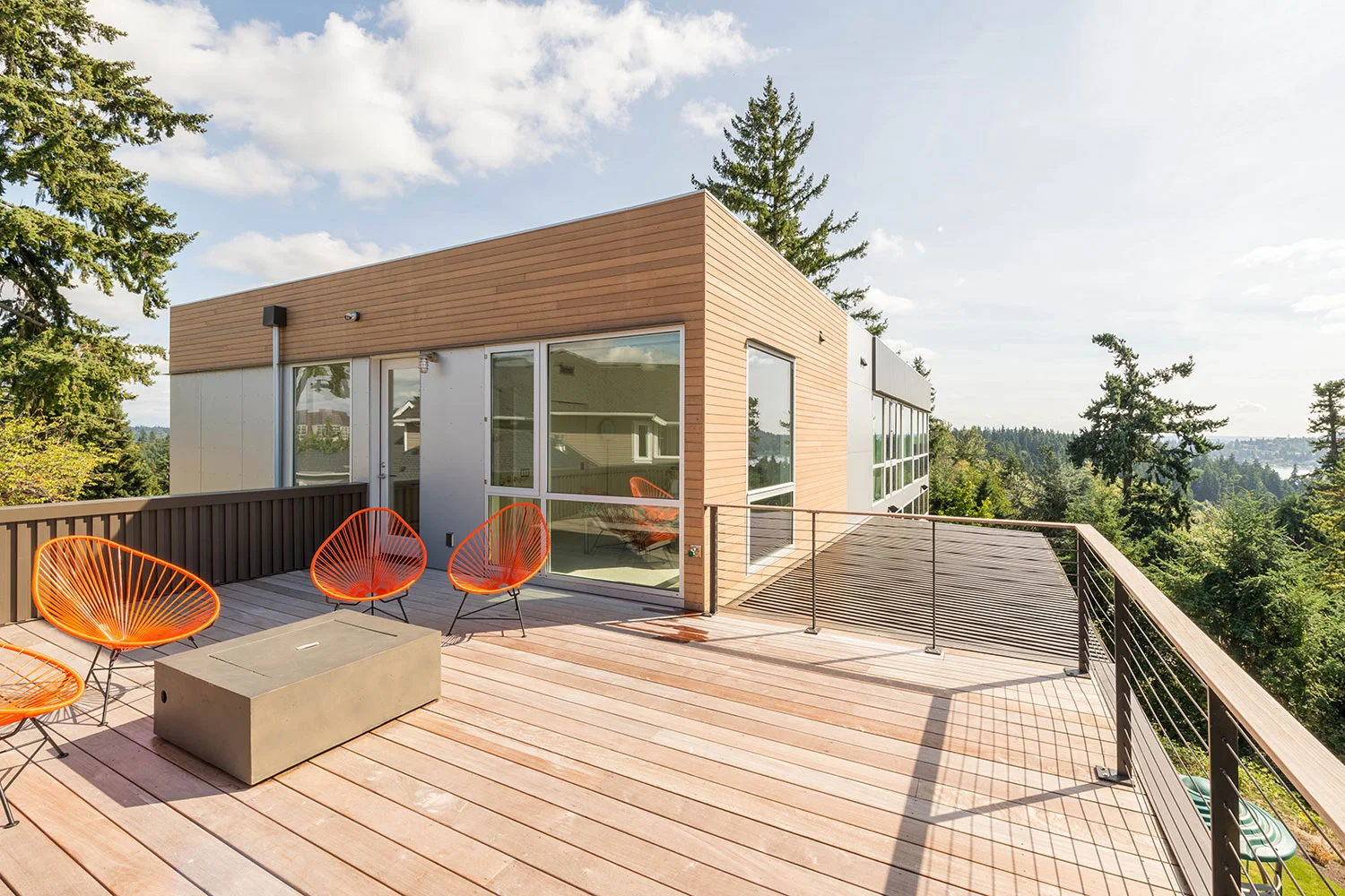 Bellevue, Washington Perched to capture views of Seattle, the Puget Sound, the Olympic Mountain Range and Mount Rainier this substantial remodel of an existing home focuses on sightlines, natural light, and indoor-outdoor relationships. Because an existing foundation is reused in a steep slope area, the new work maintains the line of the existing footprint and maximizes vertical expansion. A simple massing keeps the structural system straight-forward and cost-effective, while a disciplined interior and thoughtful detailing create a timeless envelope. The floor plan takes full advantage of a striking site while accommodating all the needs of a growing family. All images by BUILD LLC.
