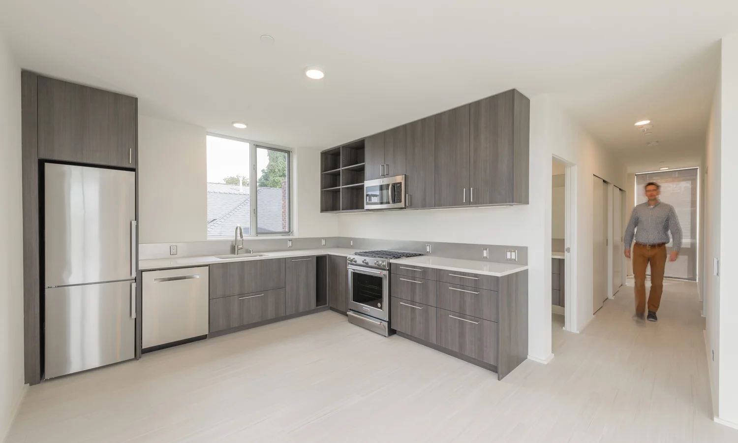 BUILD-LLC-602-unit-3-Kitchen-01-with-person.jpg