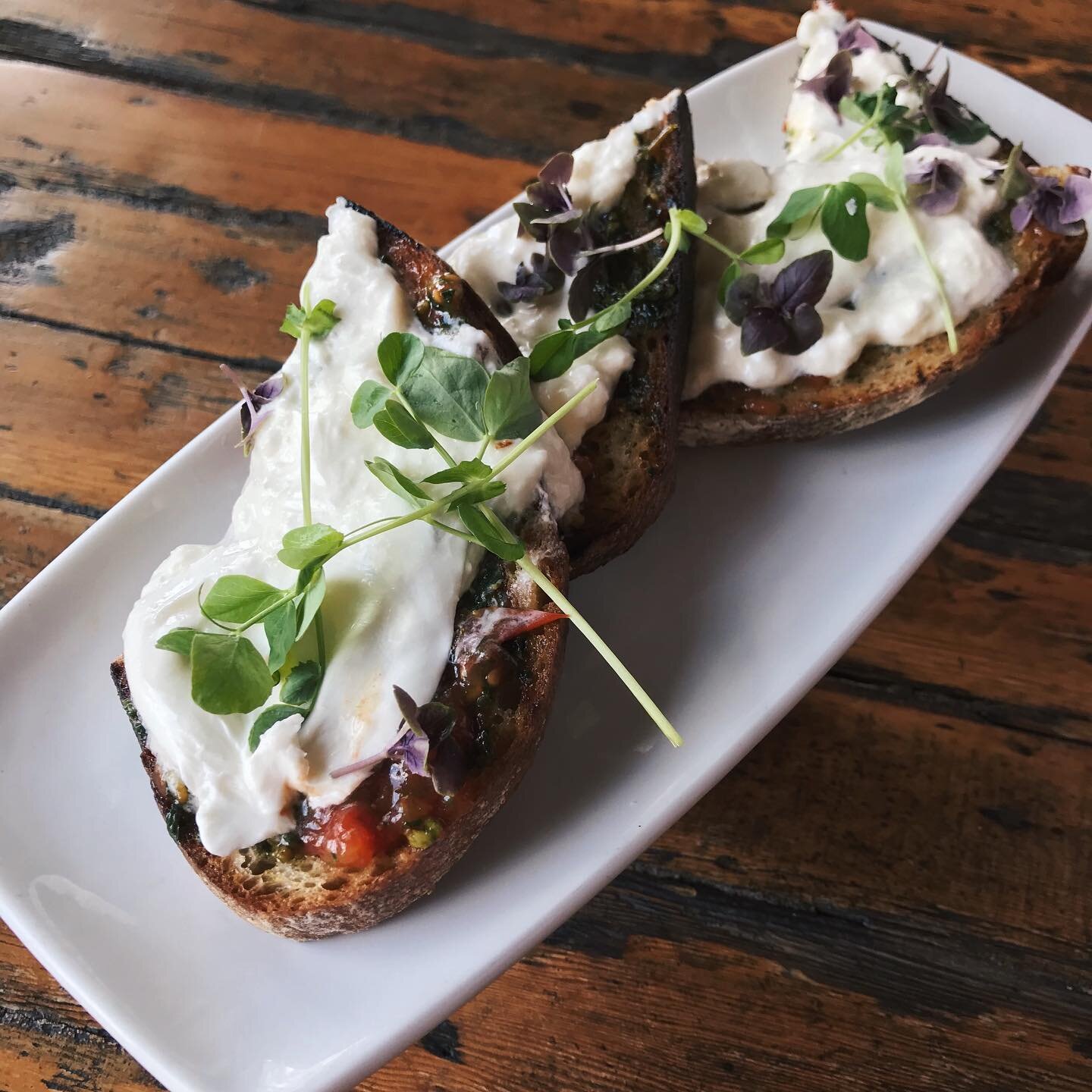 Check out our new version of a longtime favorite: burrata, pesto, local tomato jam, sea salt + fresh herbs on grilled sourdough.