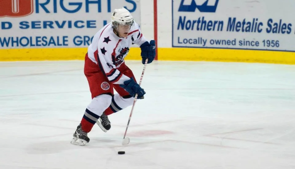 Newcomer Colin Mathieson carries the puck out of his own end in Dawson Creek's first game action of the year. (Photo credit: Carolyn Huttema)