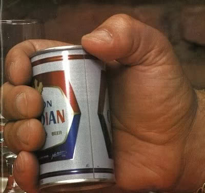Andre The Giant holding a can of beer.