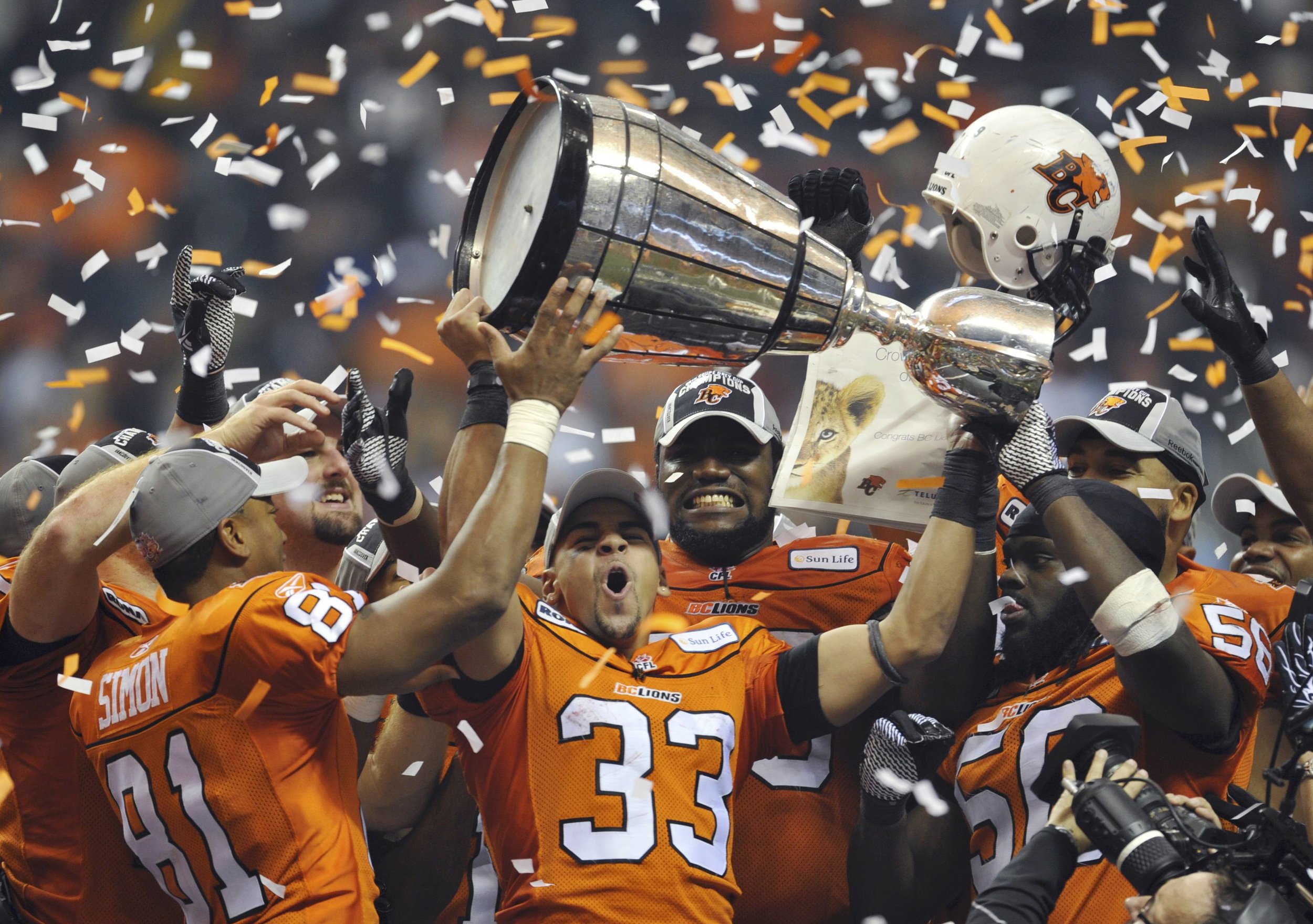 Andrew Harris (33) celebrates winning the 2011 Grey Cup with B.C., just one year removed from ruining Ryan's life.