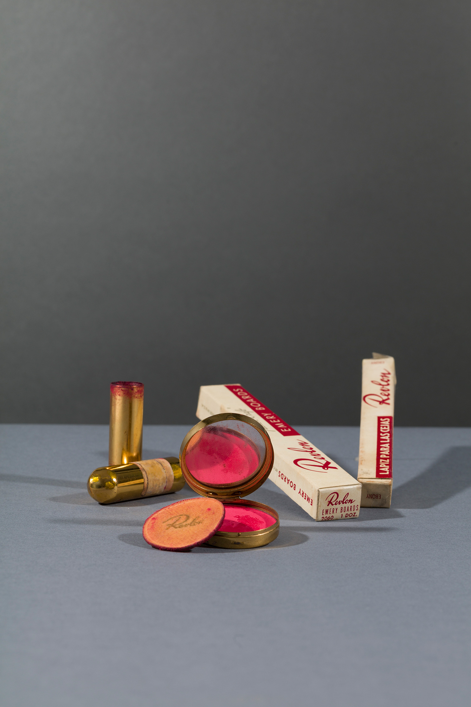 Revlon compact and powderpuff with blusher in ‘Clear Red’ and Revlon lipstick in ‘Everything’s Rosy’; emery boards and eyebrow pencil in ‘Ebony’. Before 1954. Photograph Javier Hinojosa.