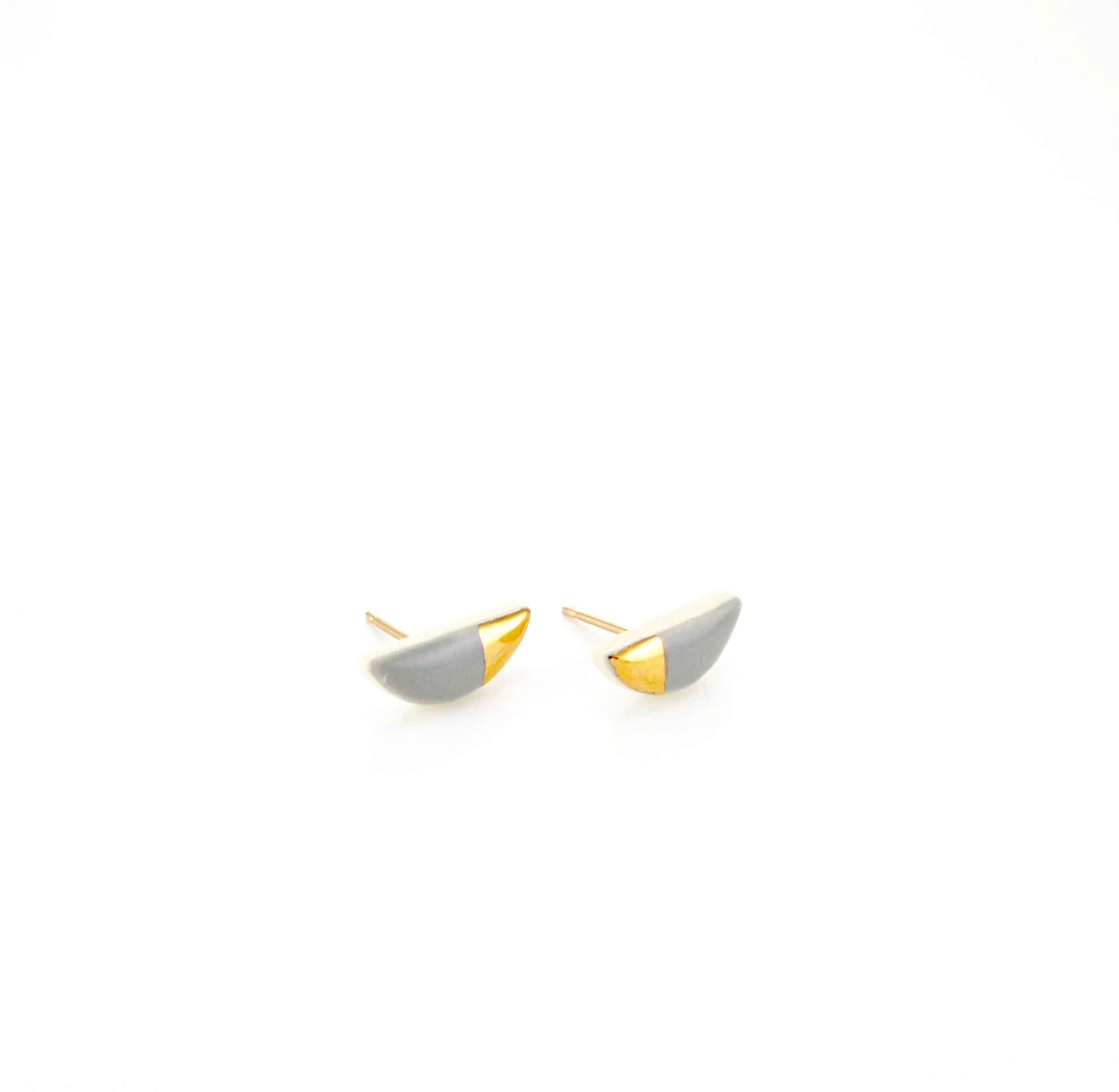 ZOË COMINGS tiny half pebble studs dark grey:gold angle.jpg