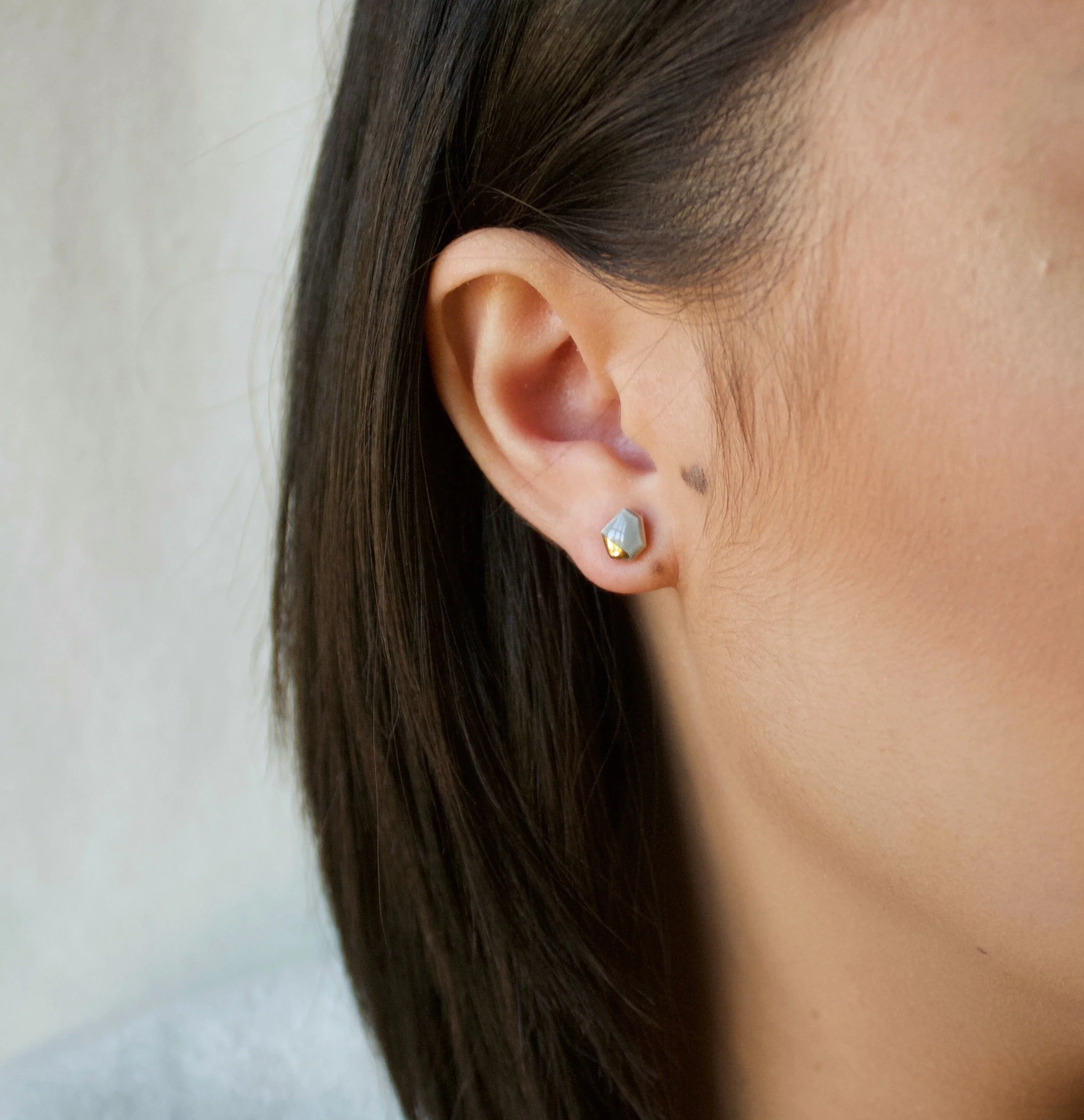ZOË COMINGS model tiny geo studs dark grey:gold sl square.jpg