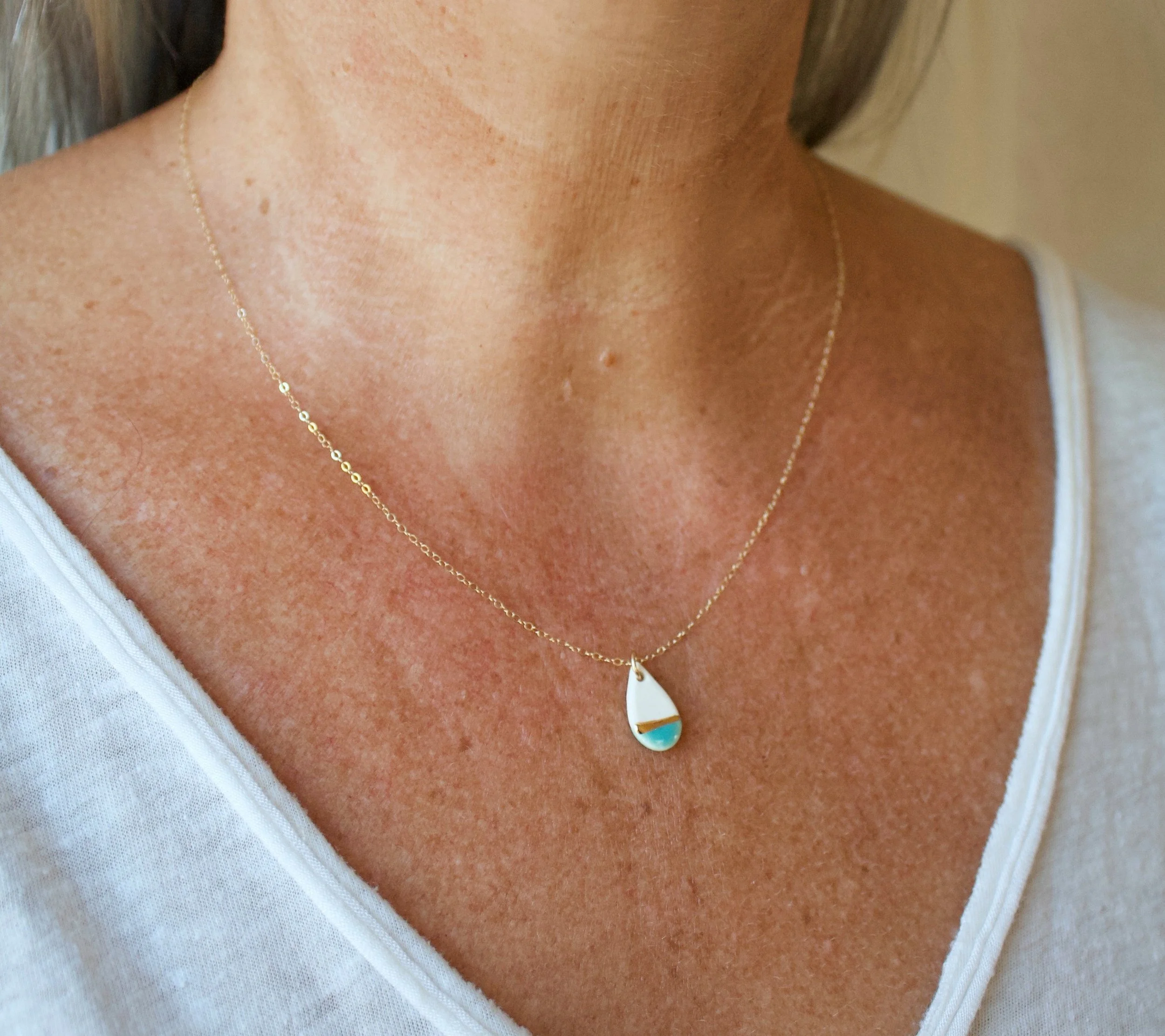 ZOË COMINGS model tiny teardrop necklace teal:gold line sl square.jpg