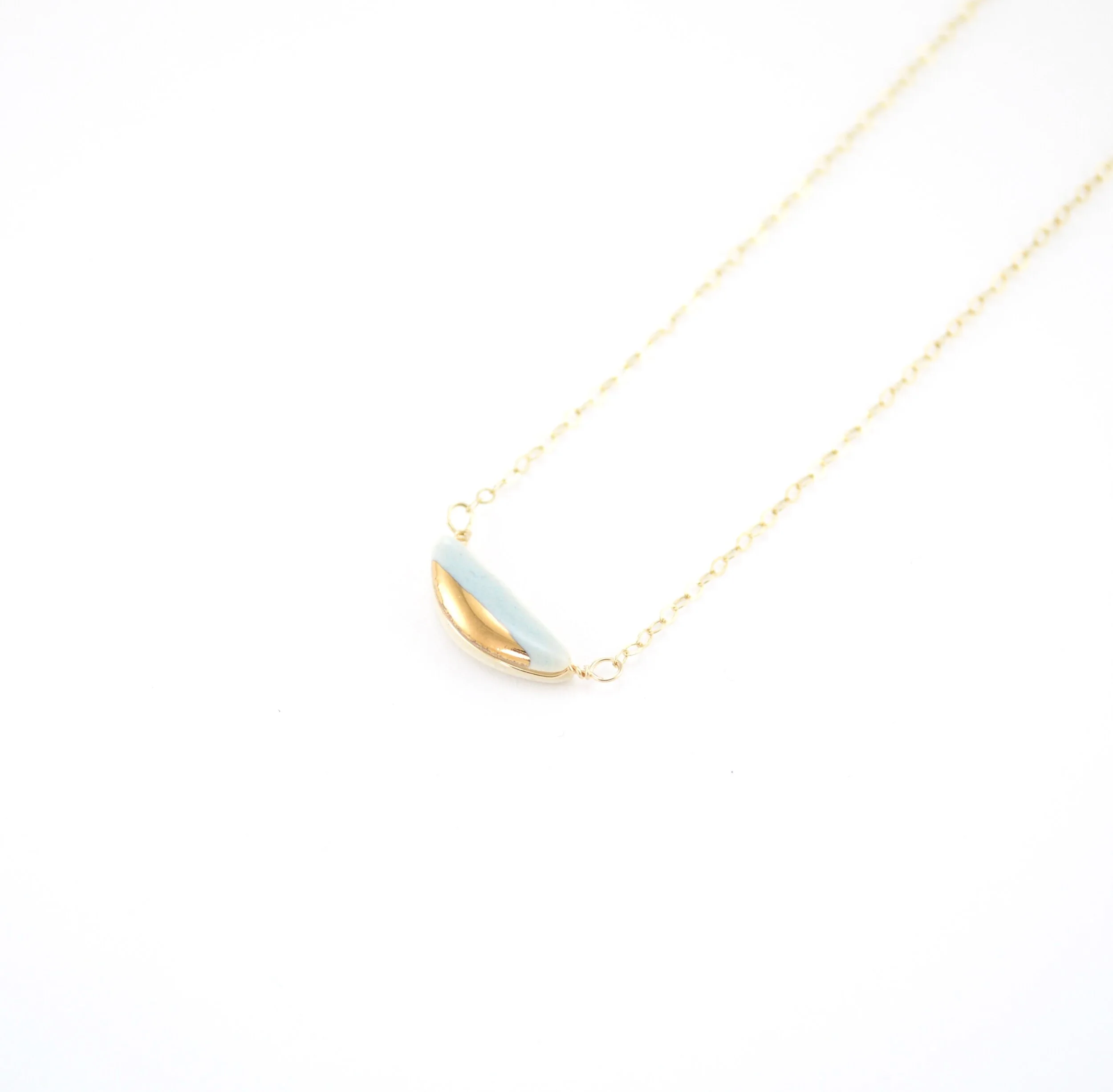 ZOË COMINGS teeny half pebble necklace pale blue:gold half.jpg