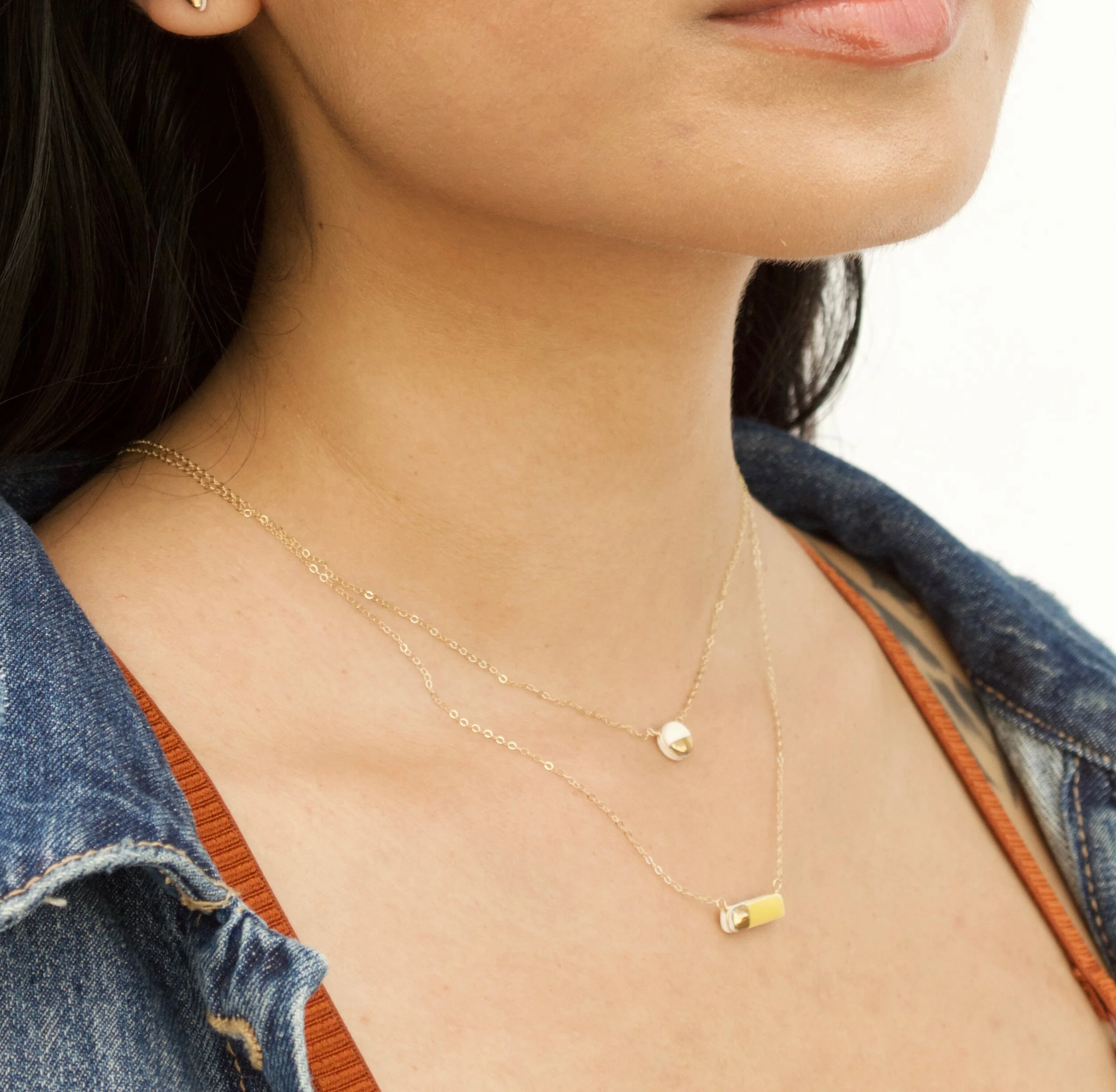 ZOË COMINGS  teeny pebble and reed necklaces white:marigold model.jpg