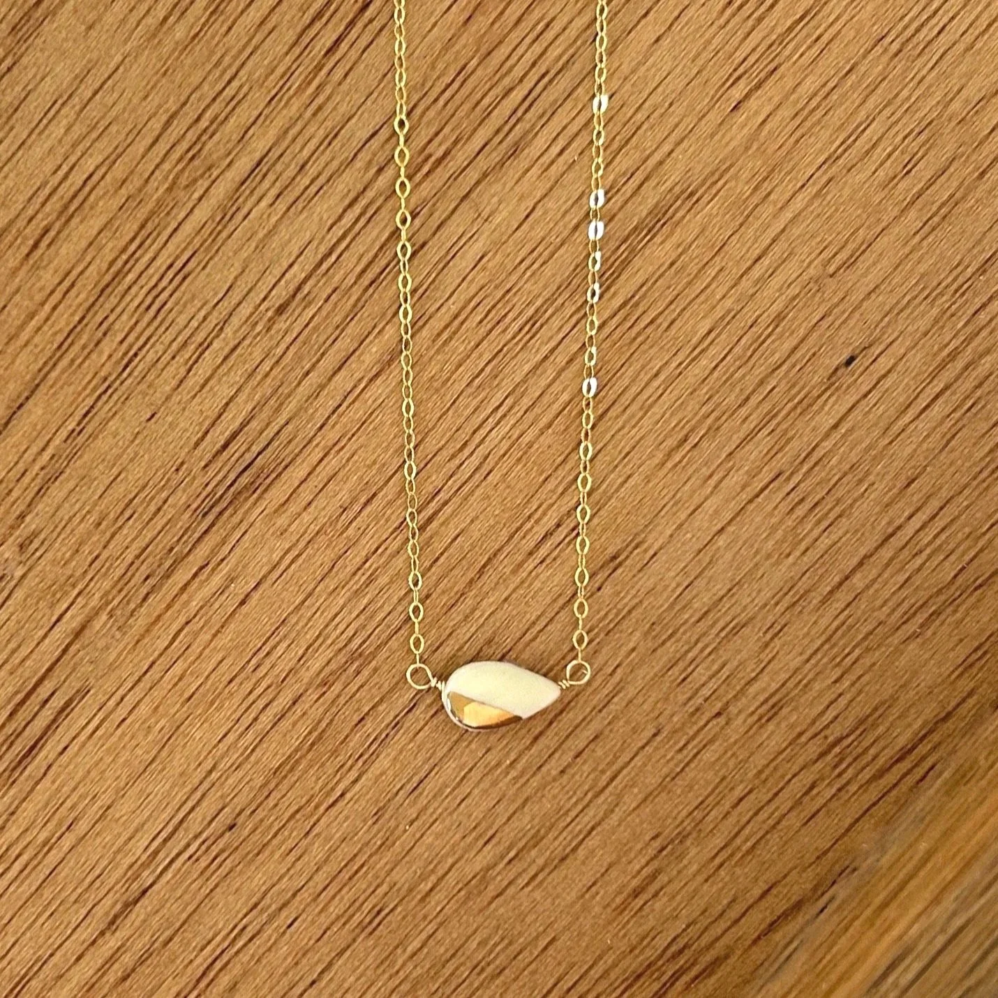 ZOE%CC%88+COMINGS+teeny+petal+necklace%2C+white%2C+wdbkg.jpg