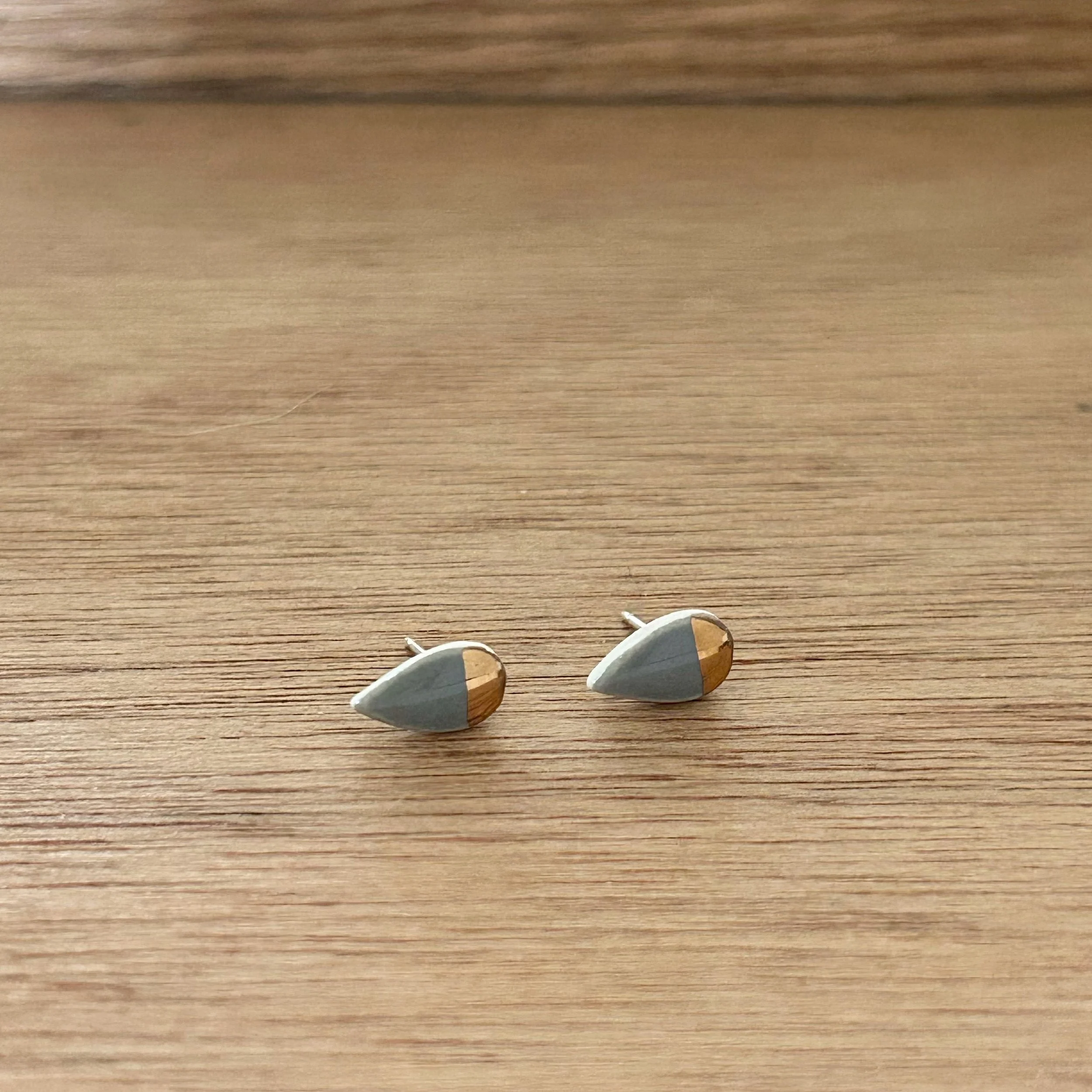ZOË COMINGS tiny petal studs, dark grey:gold half, a wdbkg.jpg