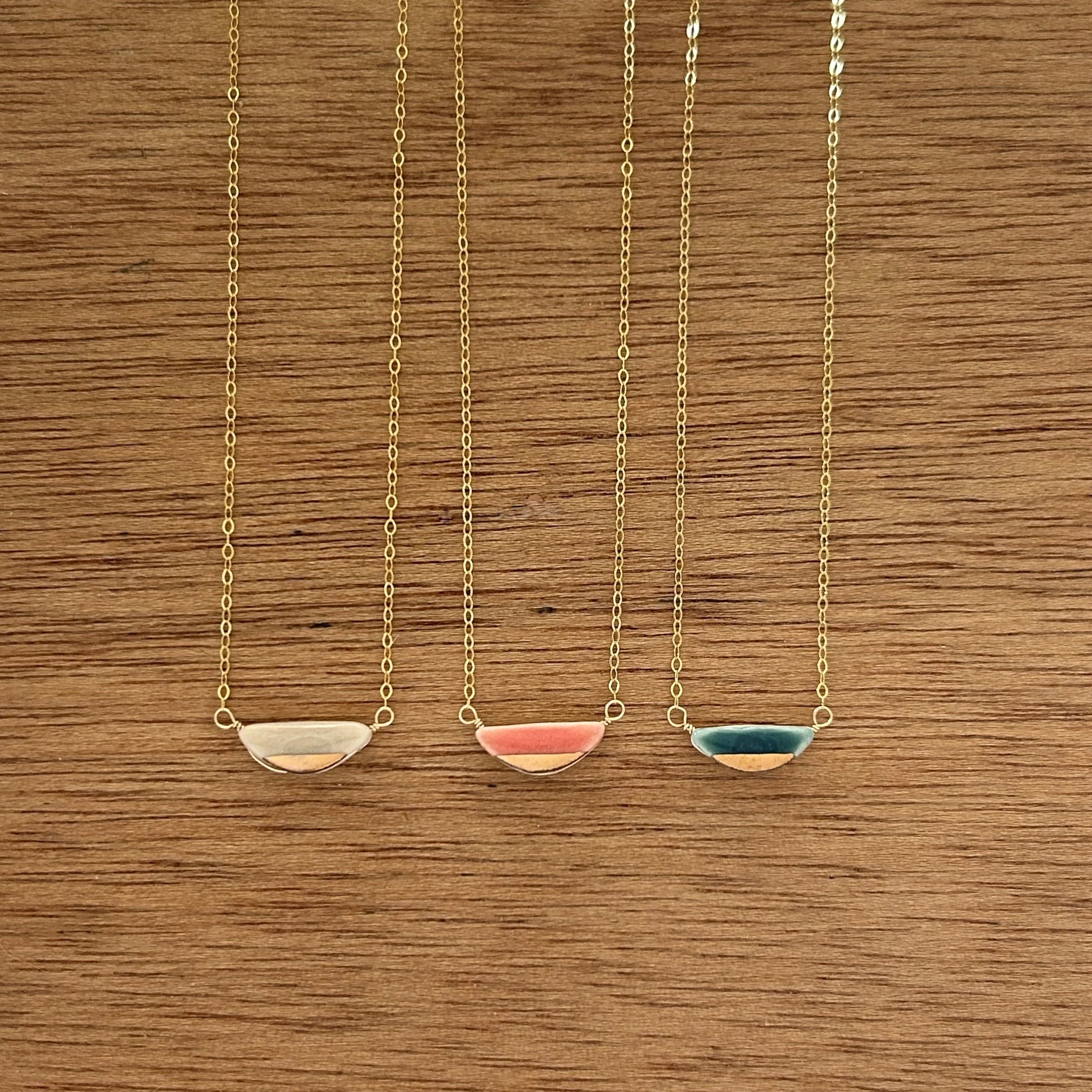 ZOË COMINGS teeny half pebble necklaces, pk:cl:sl, wdbkg.jpg