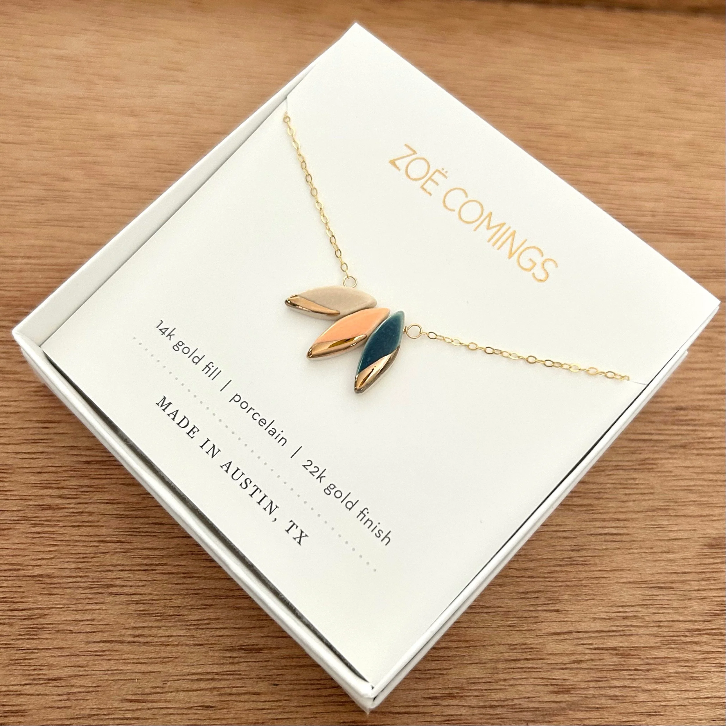 ZOË COMINGS triple leaf necklace pale pink:orange:slate boxed a.jpg