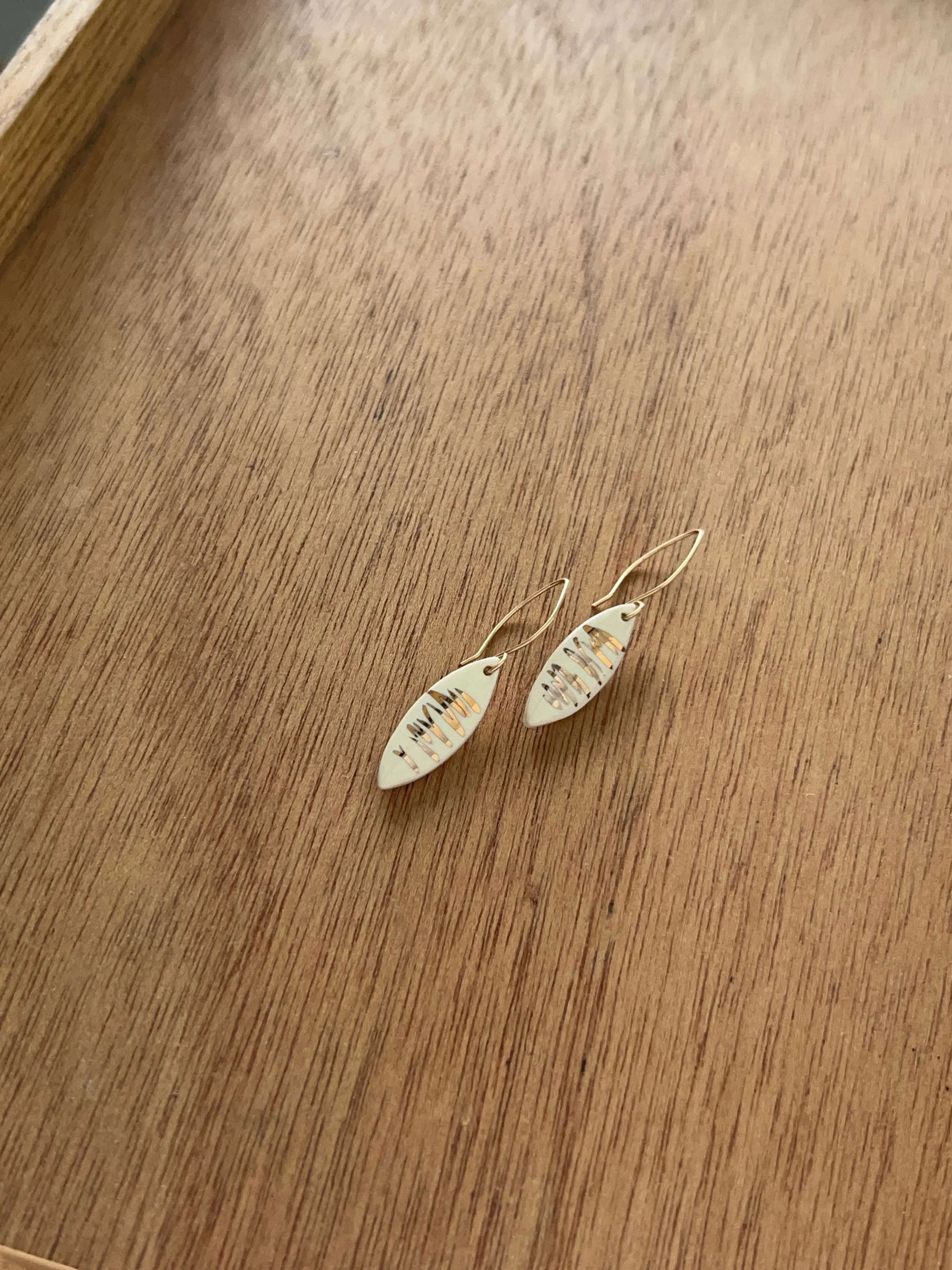 ZOË COMINGS leaf earrings, shimmer white wdbkg a.jpg