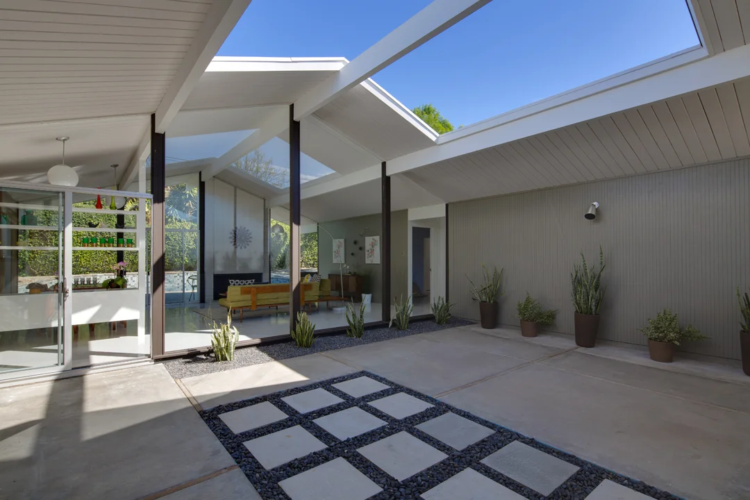 A huge, open-air atrium patio welcomes everyone as they enter the home. The amount of natural light that floods this home is unreal.