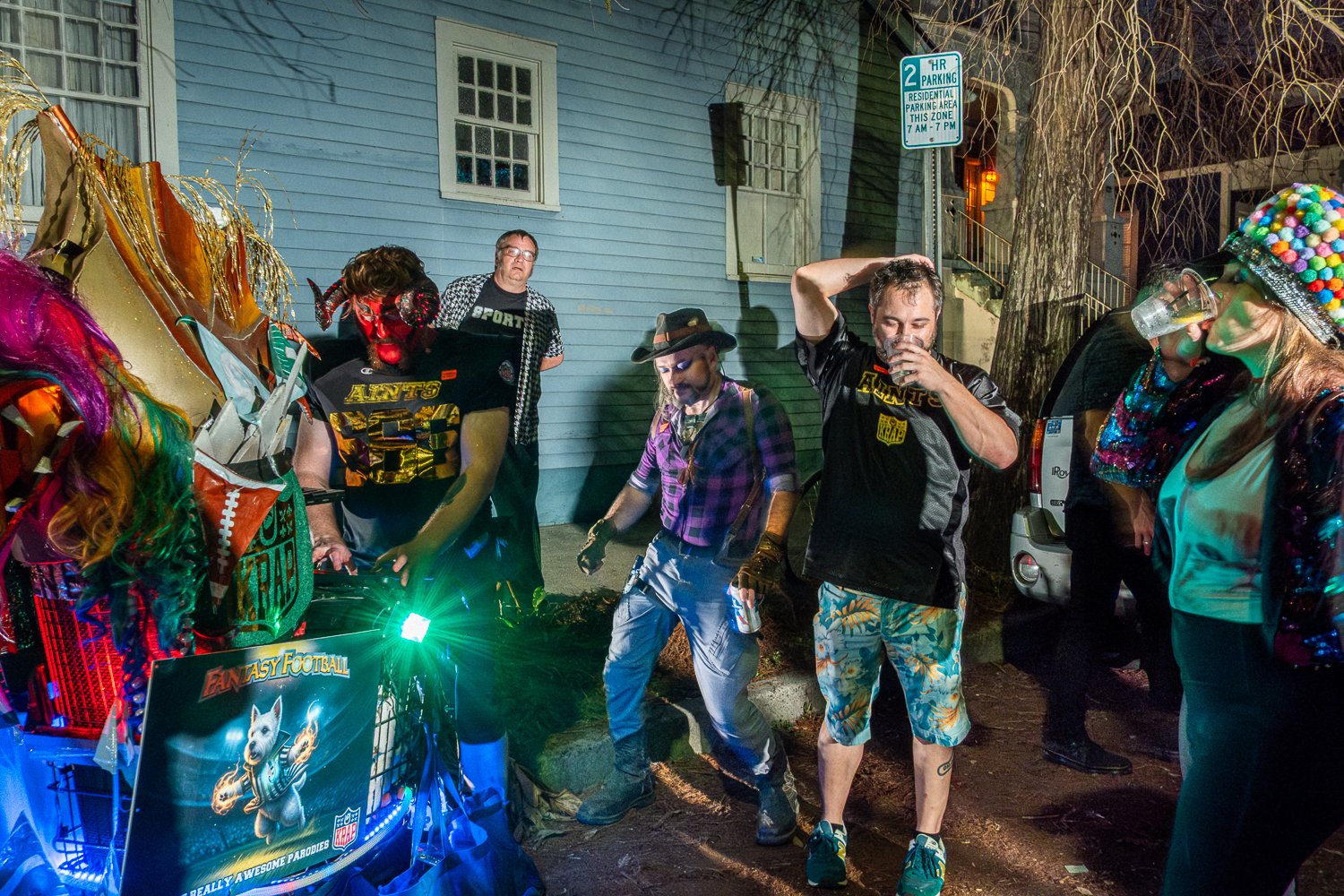 Members of the “Really Awesome Parodies” krewe dance and drink in the French Quarter during Super Bowl week in New Orleans, photographed by editorial photographer Bill McCullough for a reported feature.