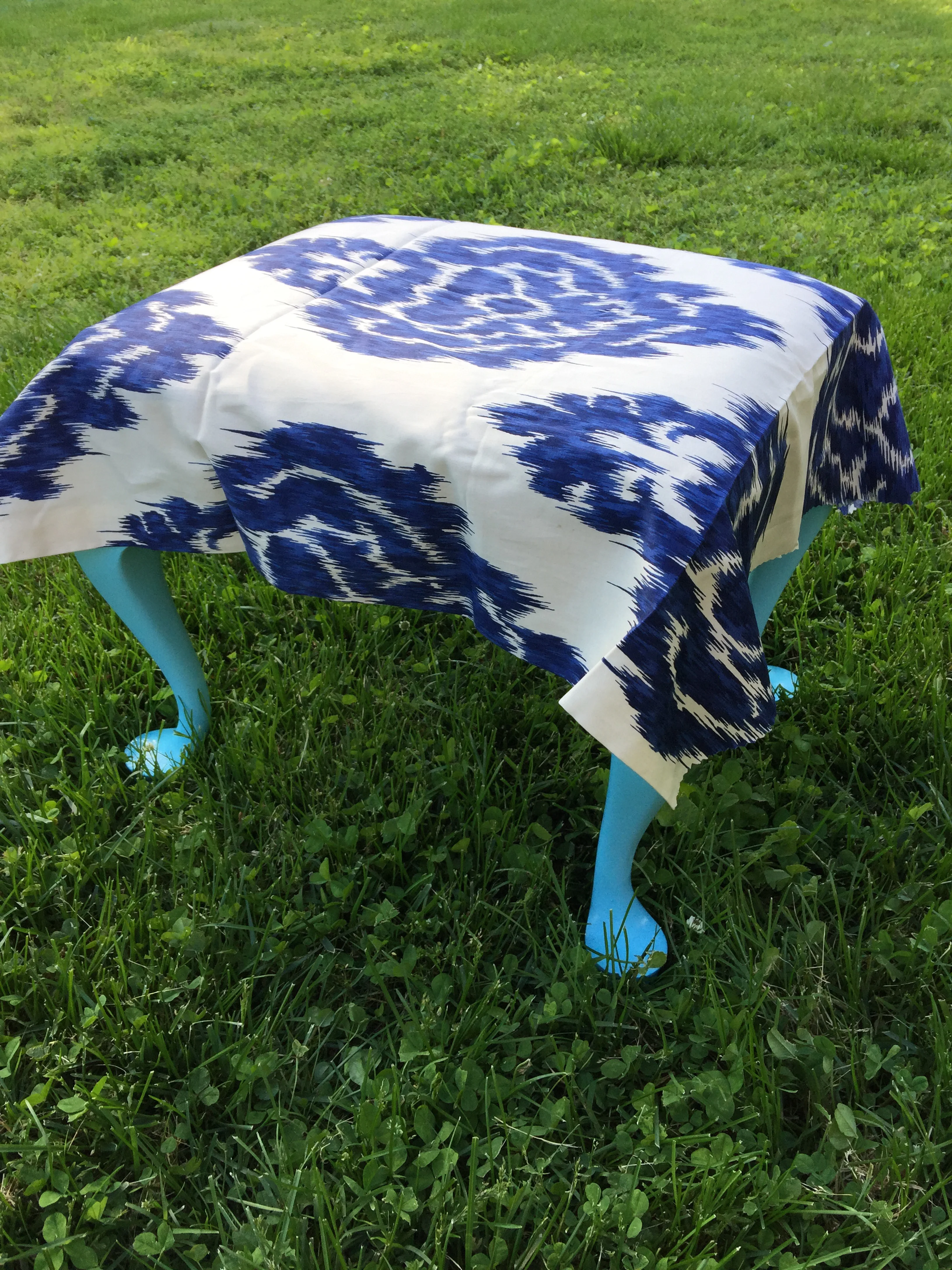 Then I positioned the fabric on the ottoman.