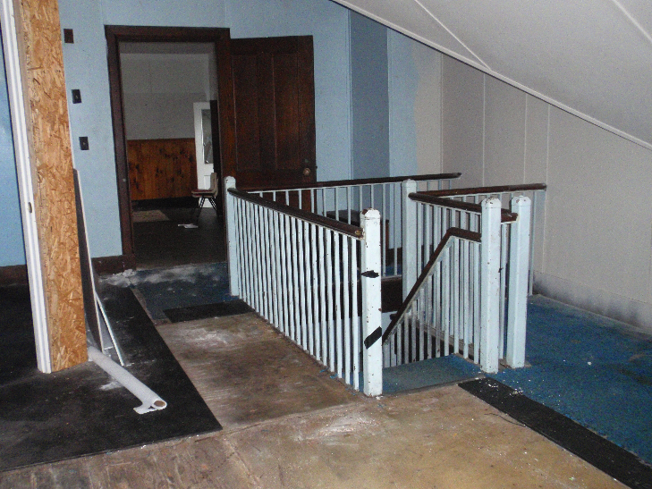  Stairs leading from the upstairs office area to the men's locker rooms. 