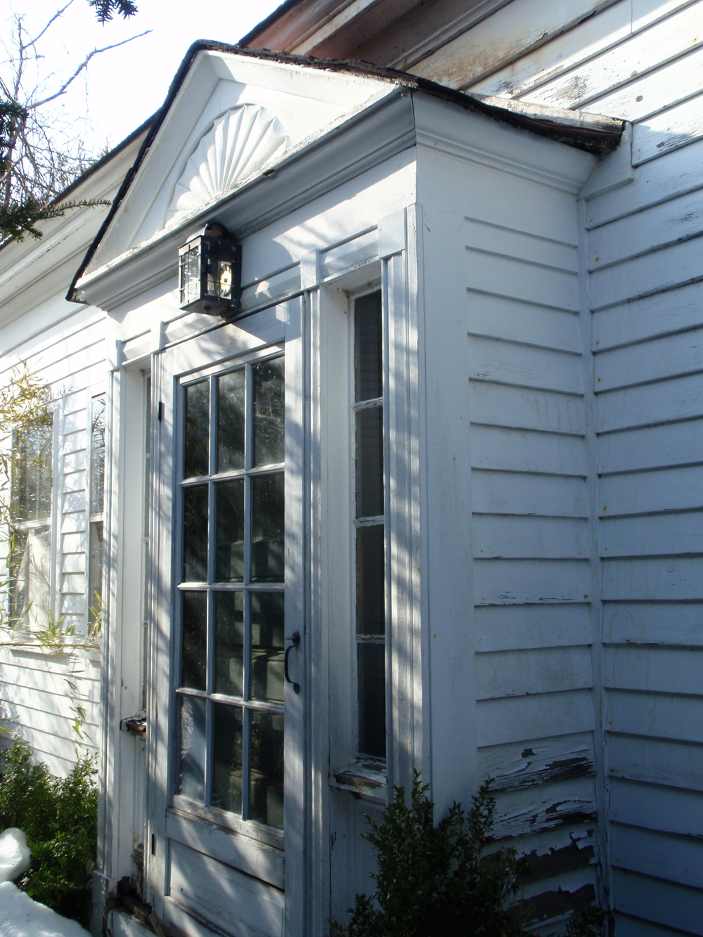  The main entry, which is centered on the house. The entry is typical of the transition between the Federal and Greek Revival styles, and of the buidling's construciton date of 1830. 