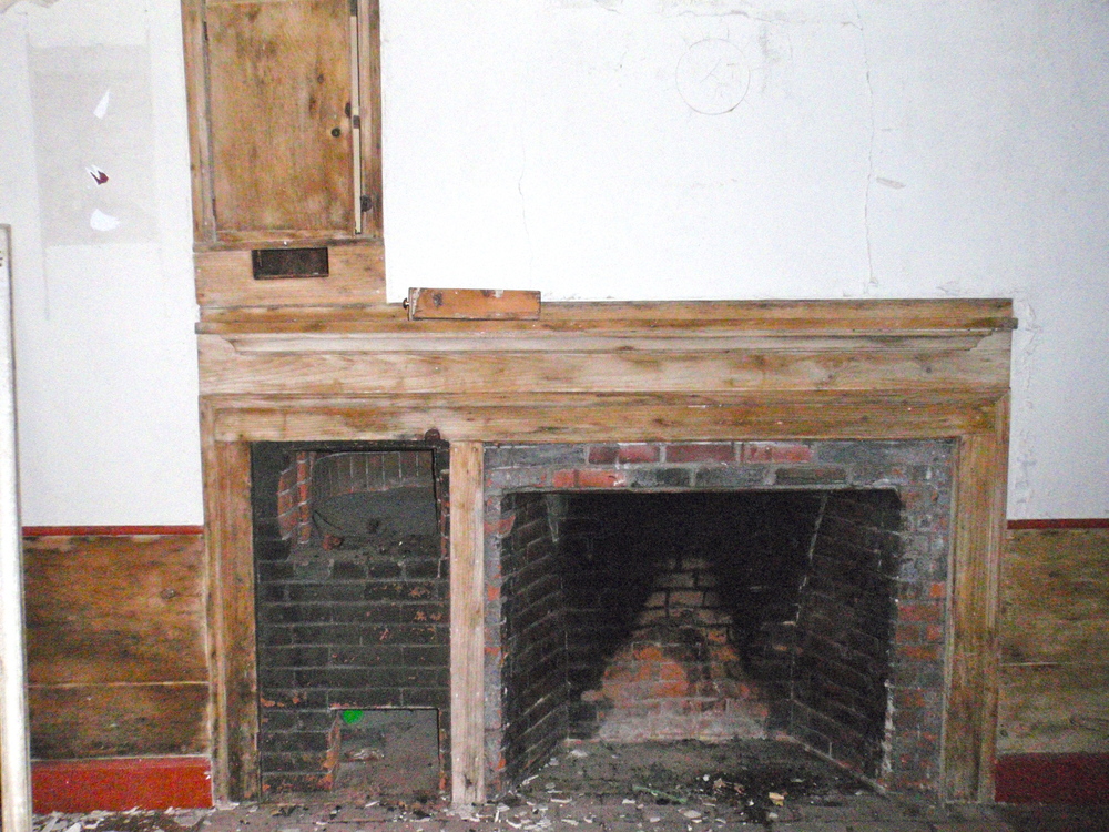  The fireplace in the historic kitchen has a bake oven to the left. The mantel, while original, has unfortunately been stripped of paint. 