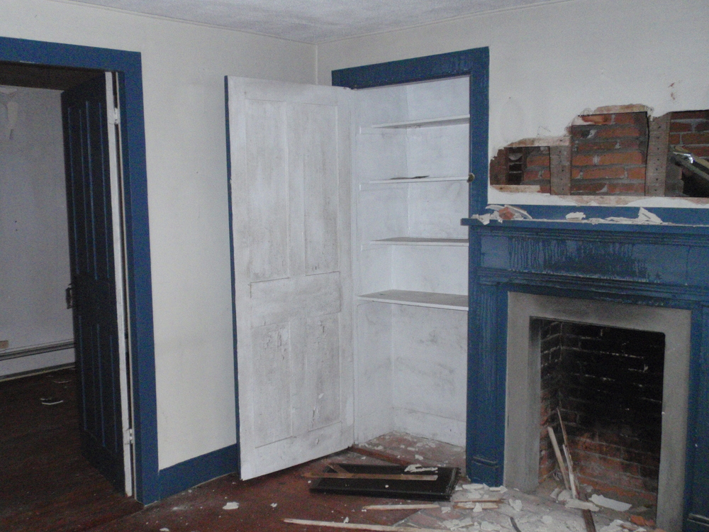  The fireplace and built-in closet in the parlor. This room was built to be a more formal space, as its fireplace was not built with a bake oven. 