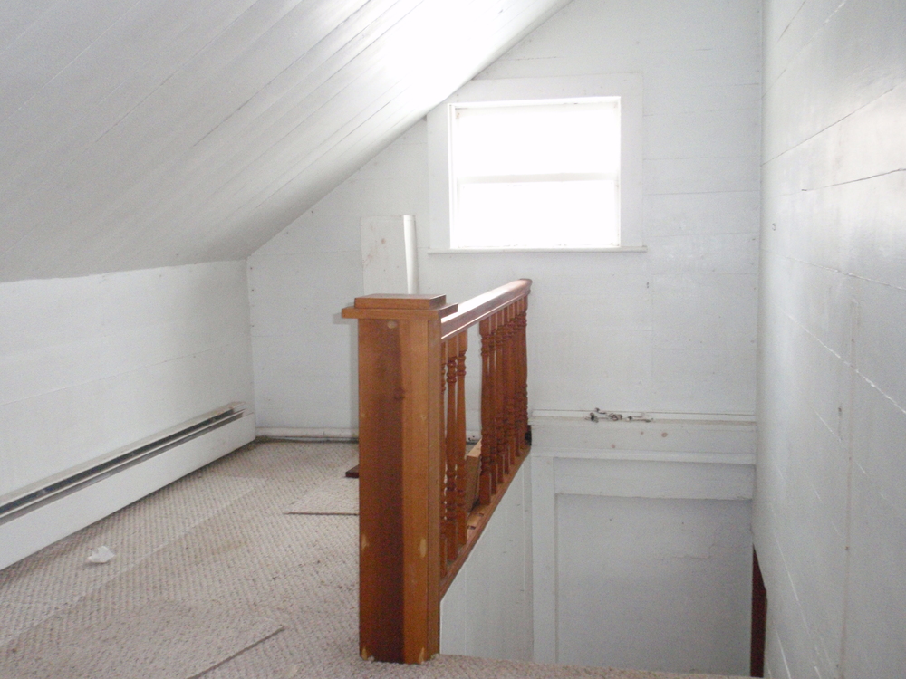  The hallway on the second story has an original three-over-three operable sash window. This means that the top half of the window has three lights, or squares of glass, and the bottom also has three lights, and the window can be opened. 