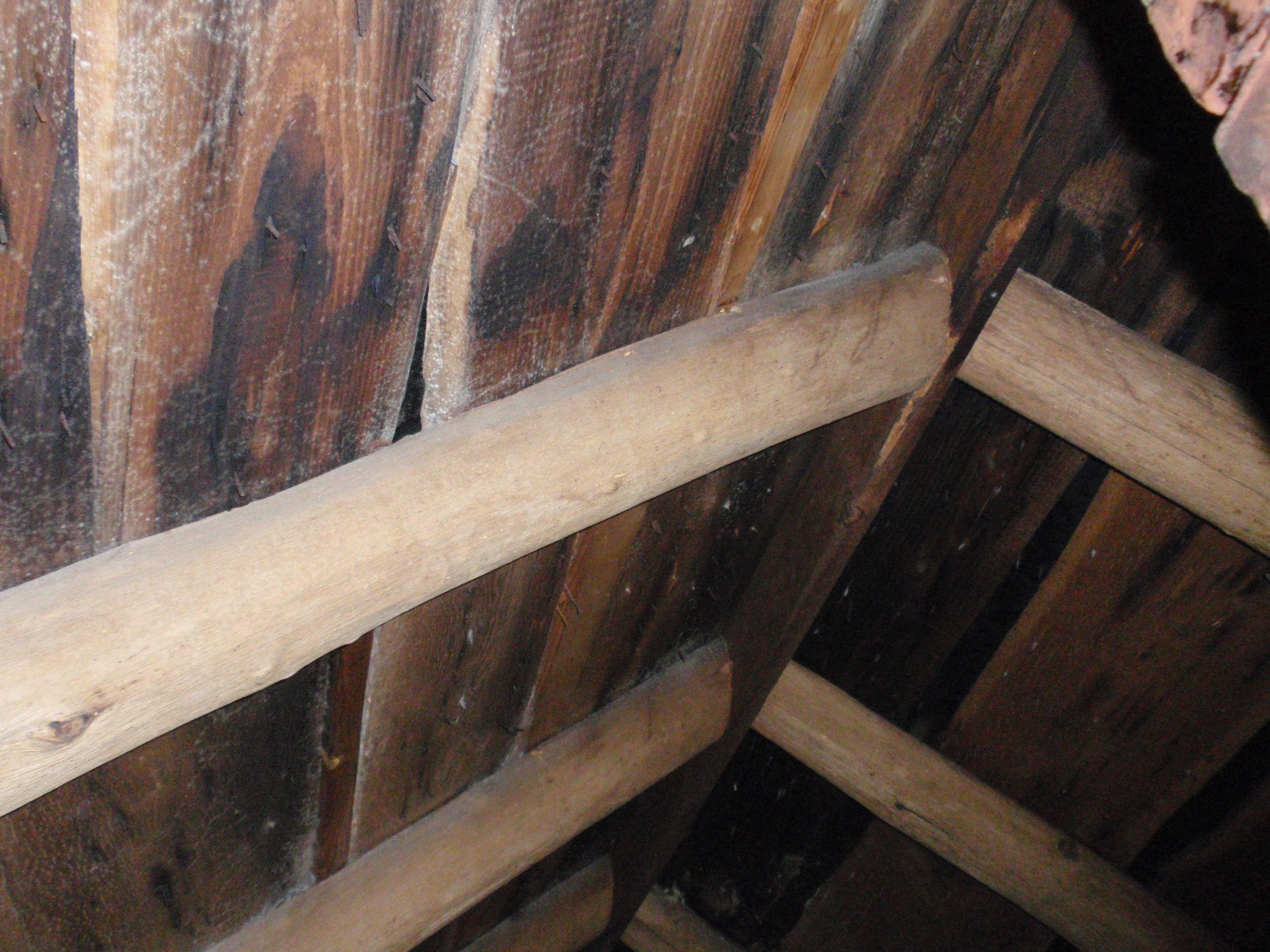  Another clue to the building's construction date is its framing. The framing members are smaller than those from the 18th century. Here in the attic/crawl space, the rafters are joined to a ridgeboard at the peak of the roof. Before about 1820, this