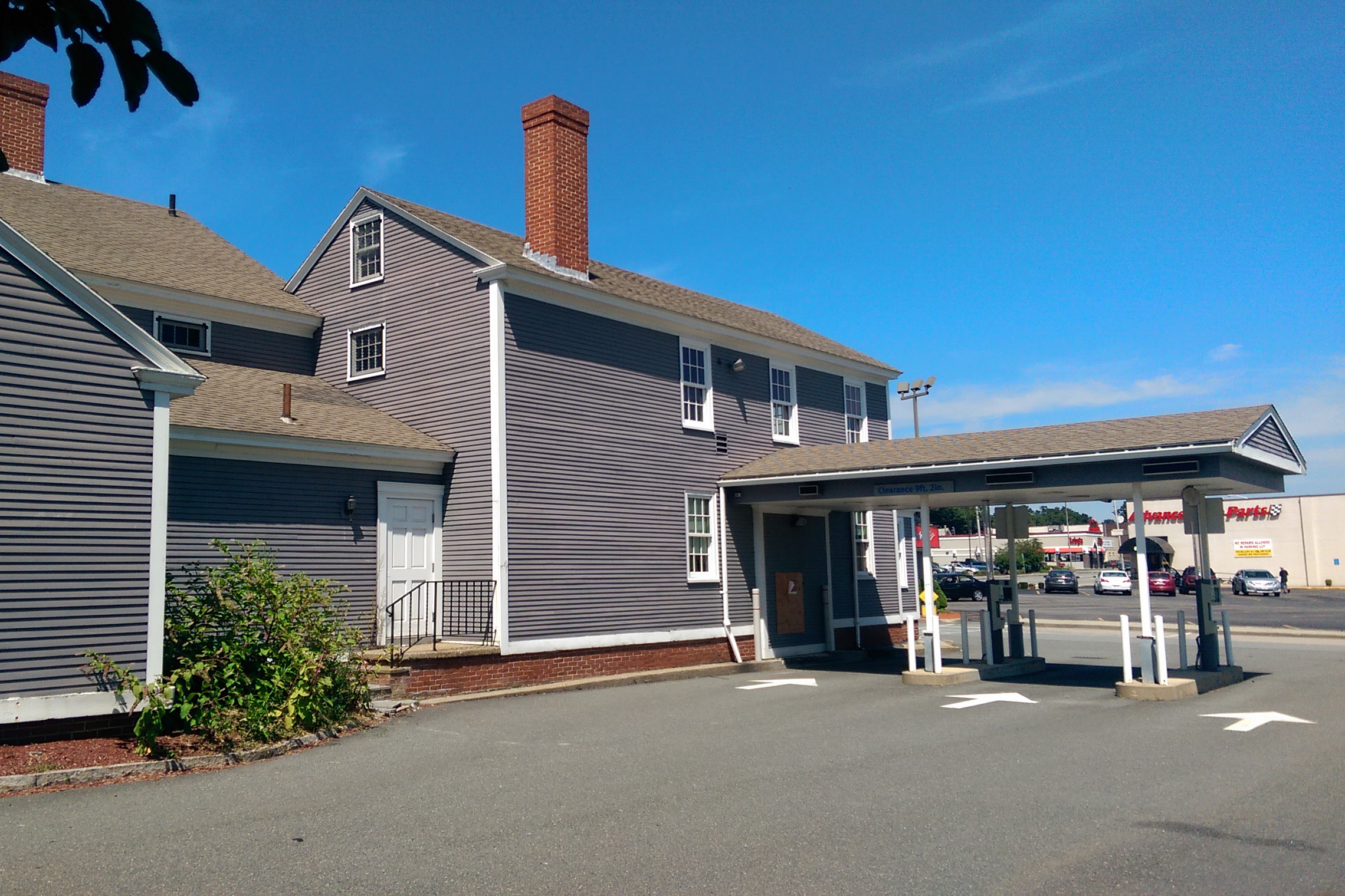 The rear of the Stearns Tavern, behind the two-story ell on the side of the house. An ell was removed when the building was moved, and replaced with the bank's drive-through.