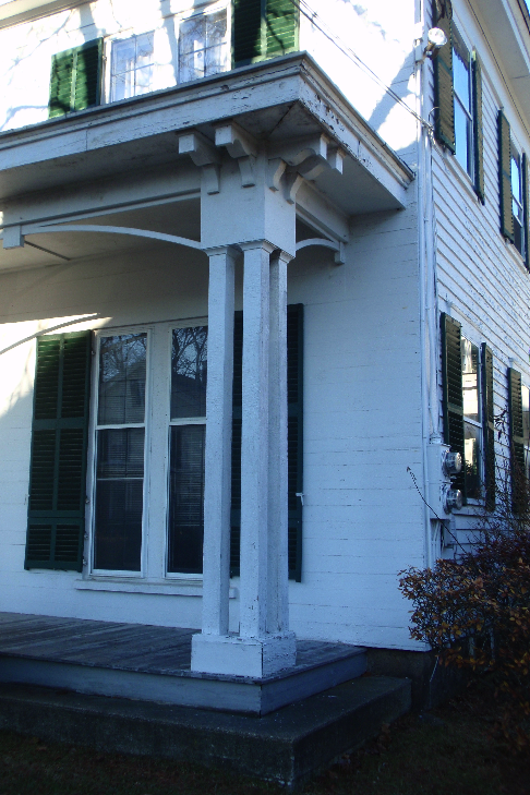  A detail of the front porch, which was likely added later in the 19th century, after the house was built. The front of the house is also distinguished by its ship-lap siding, in comparison to the more traditional clapboards on the rest of the buildi