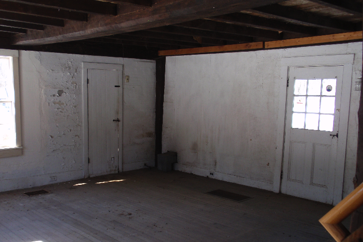  The original McFarland-Sanger House was only one room, roughly 13' by 18'. The heavy summer beam running down the middle of the room is just barely visible. The main entry door is behind the photographer. 