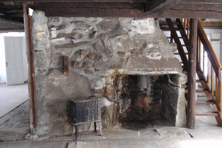  The large stone fireplace dominates the space. 