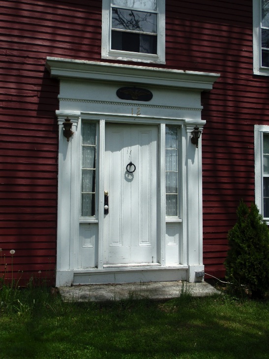 The Greek Revival main entry surround