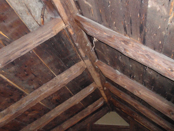 The framing in the attic, showing the rafters pegged into the five-sided ridgebeam