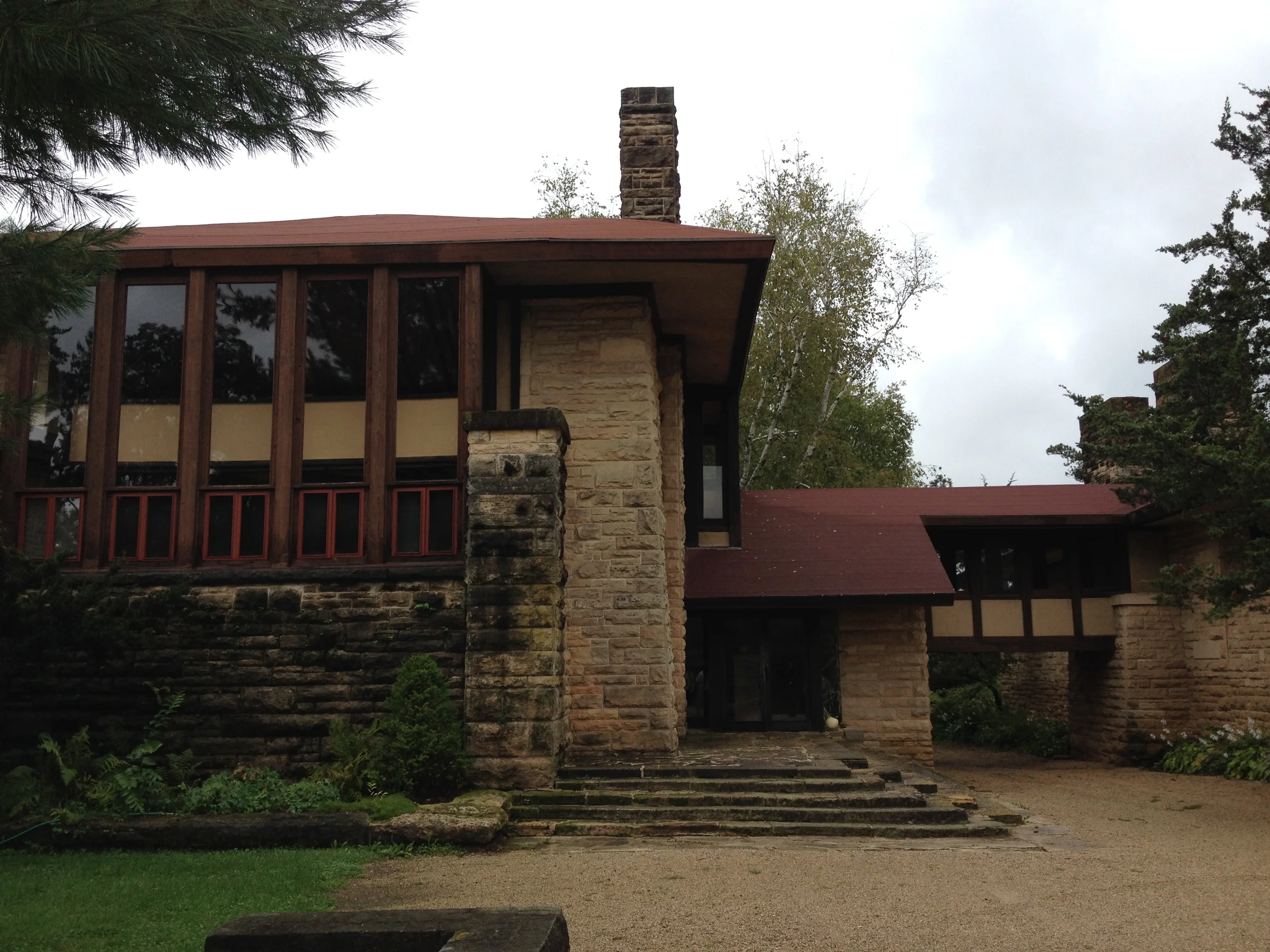 Entrance facade for the school. Two-story great room is on the left and drafting studio is on the right.