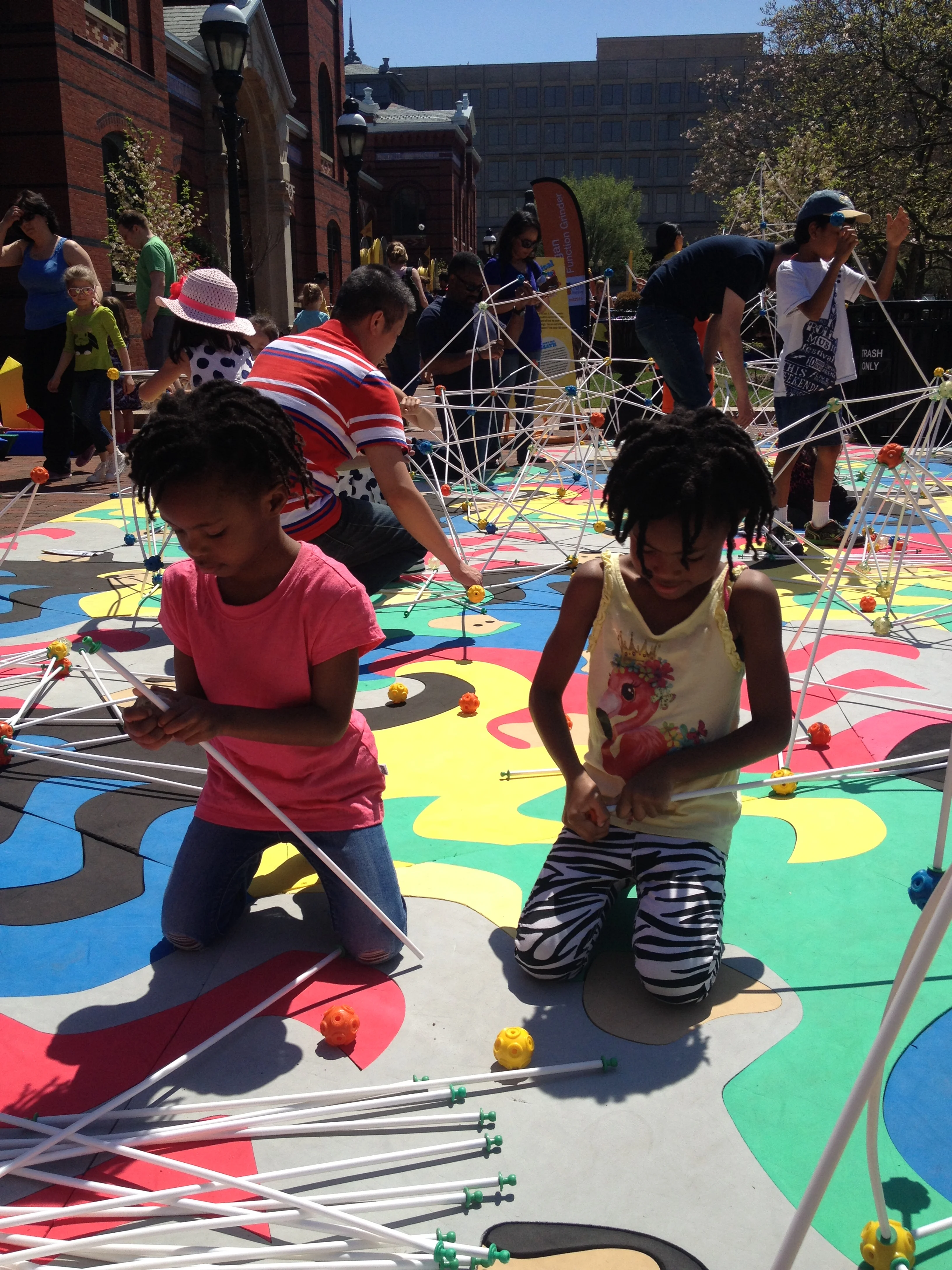 LaShae's daughters at Smithsonian's MathFest on the National Mall - learning how to build structures.
