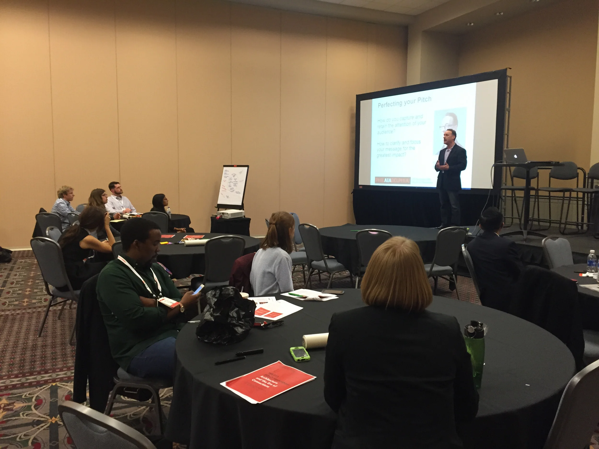 Teams listen to Anthony Gold for tips on delivering the Pitch.