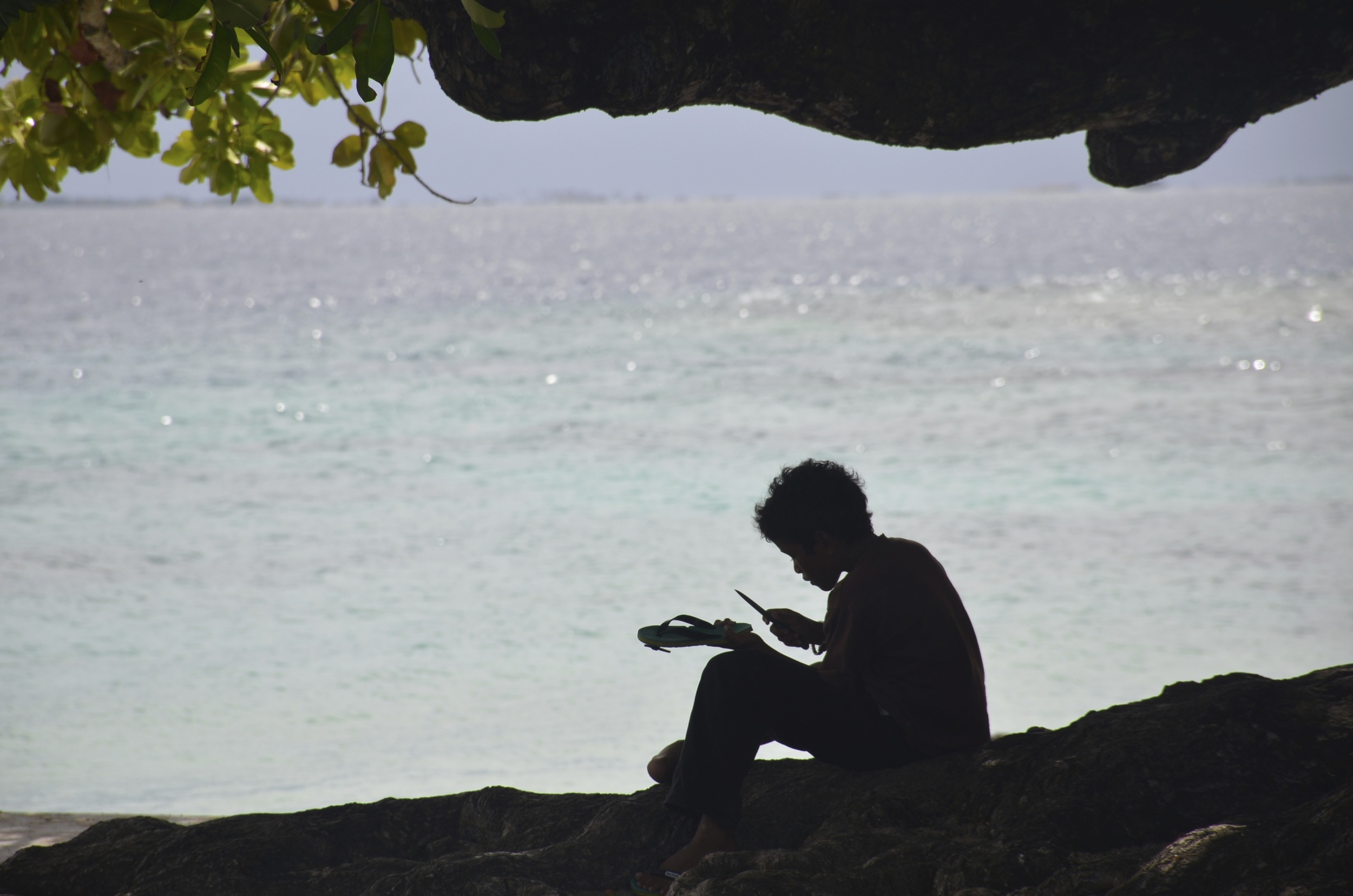  A boy on Ejit Island fixes his sandal. 