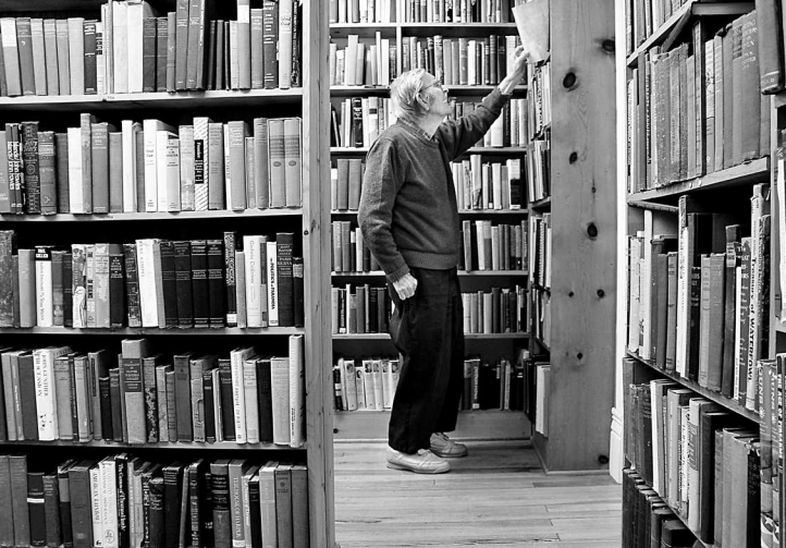 On the Bookhouse’s second floor, Edward Hughes hunts for an illustrated catalogue of Chinese bronzes for a customer. (Photo by Dan Zak / The Washington Post)