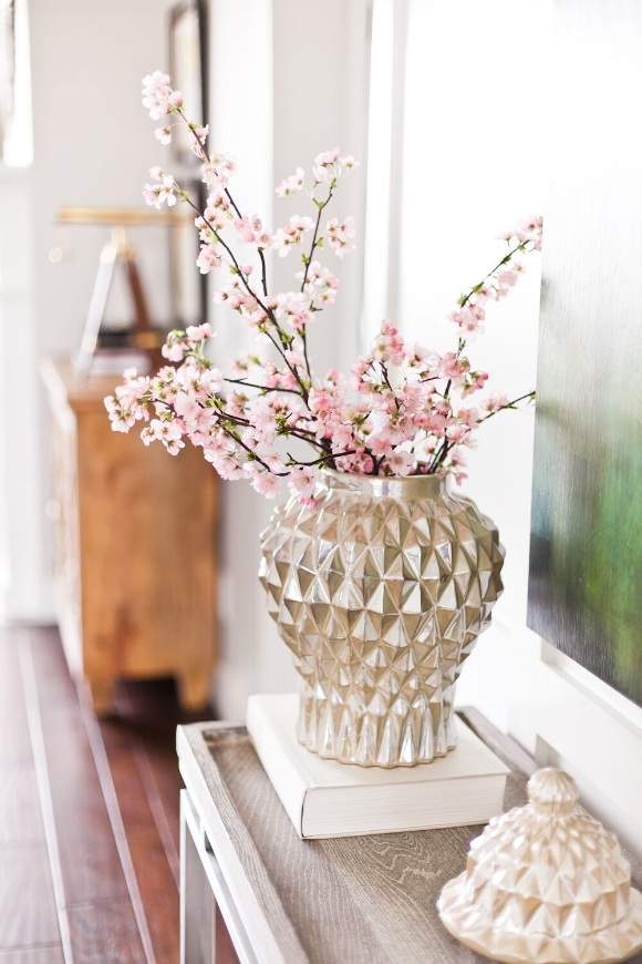 These pink flowering branches of a cherry tree work perfectly with the geometric silver vase.