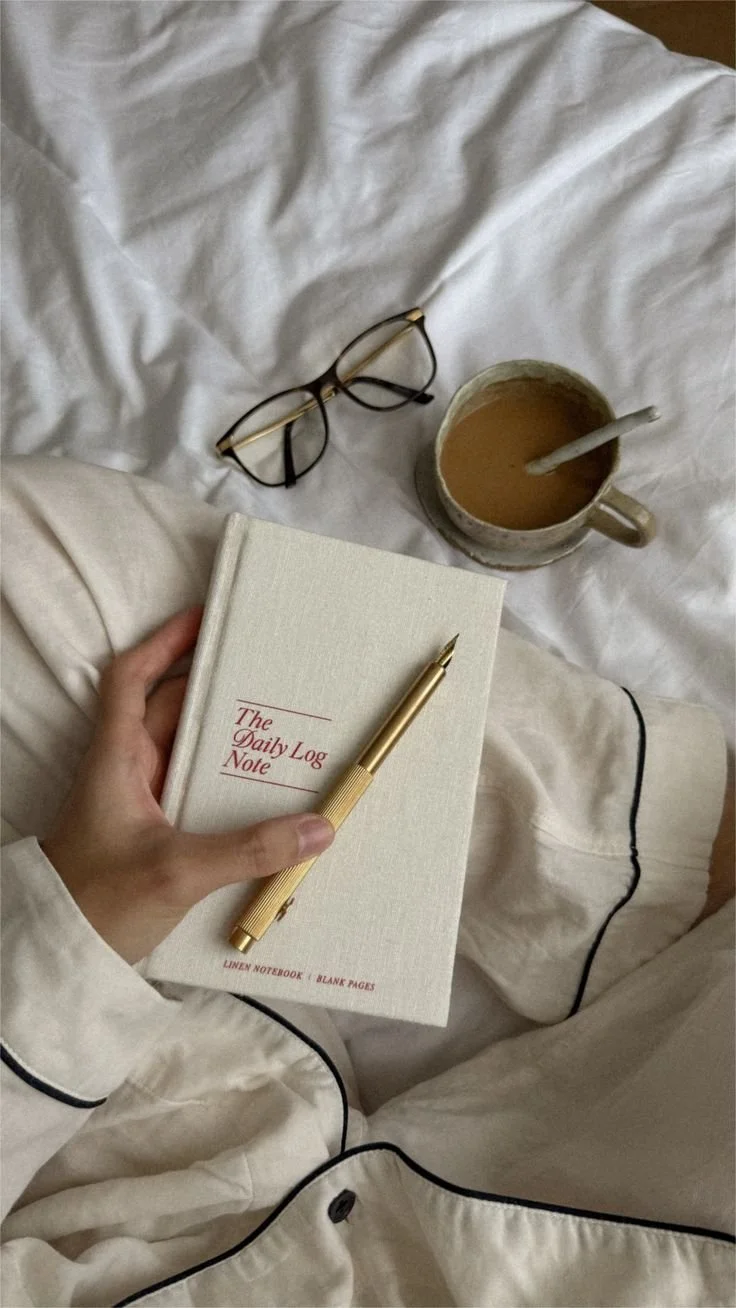 hellolovelyliving woman writing in journal bed