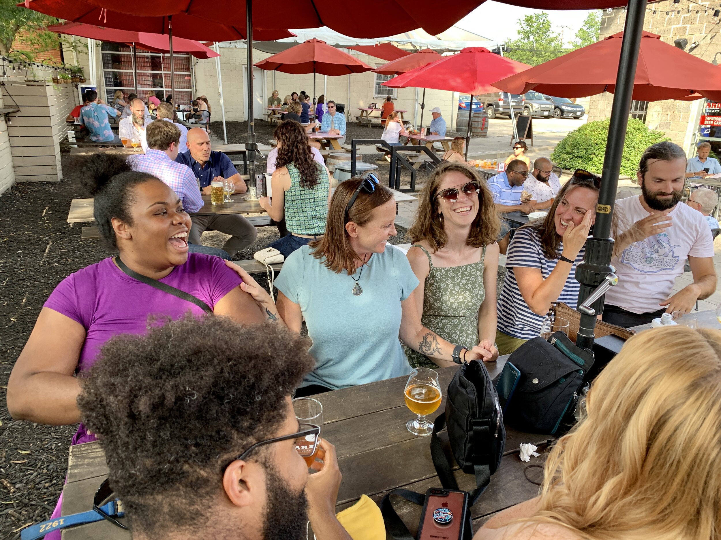 beer garden Sunday table full of people smiling laughing.jpg