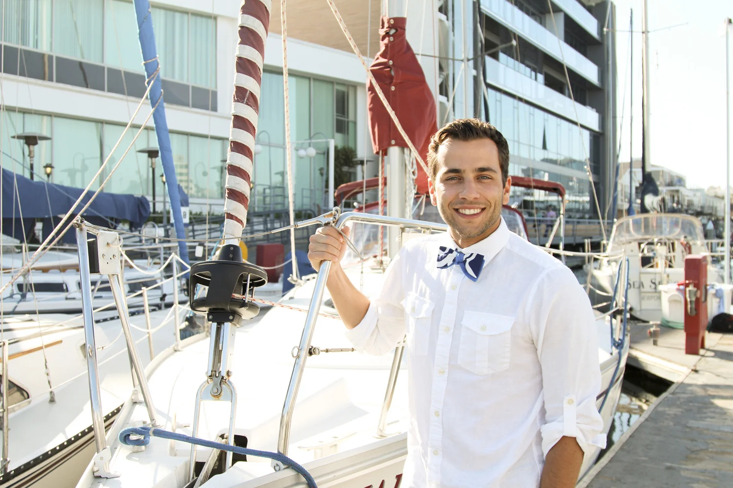 White cotton button down shirts with double pockets are extremely versatile. They are simple, yet the pockets help break-up the otherwise plain shirt. Pairing this white shirt with a casual bow tie then classes up the look and gives the pop of color while remaining subtle, and dapper.