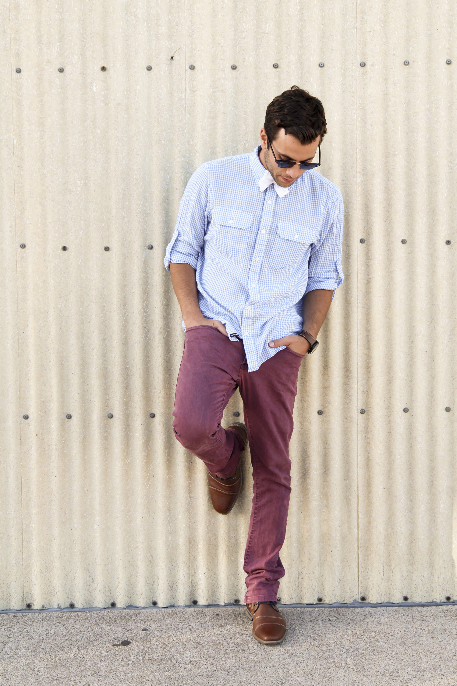  A guy wearing a blue and white checkered button down shirt and maroon pants dresses decently. &nbsp;A guy wearing that and a white bow tie, is interesting. &nbsp;In this look, sometimes a casual white bow tie is all you need. &nbsp;With the two colo