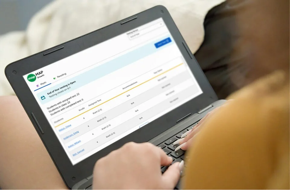 Teacher using a test monitoring interface on a laptop