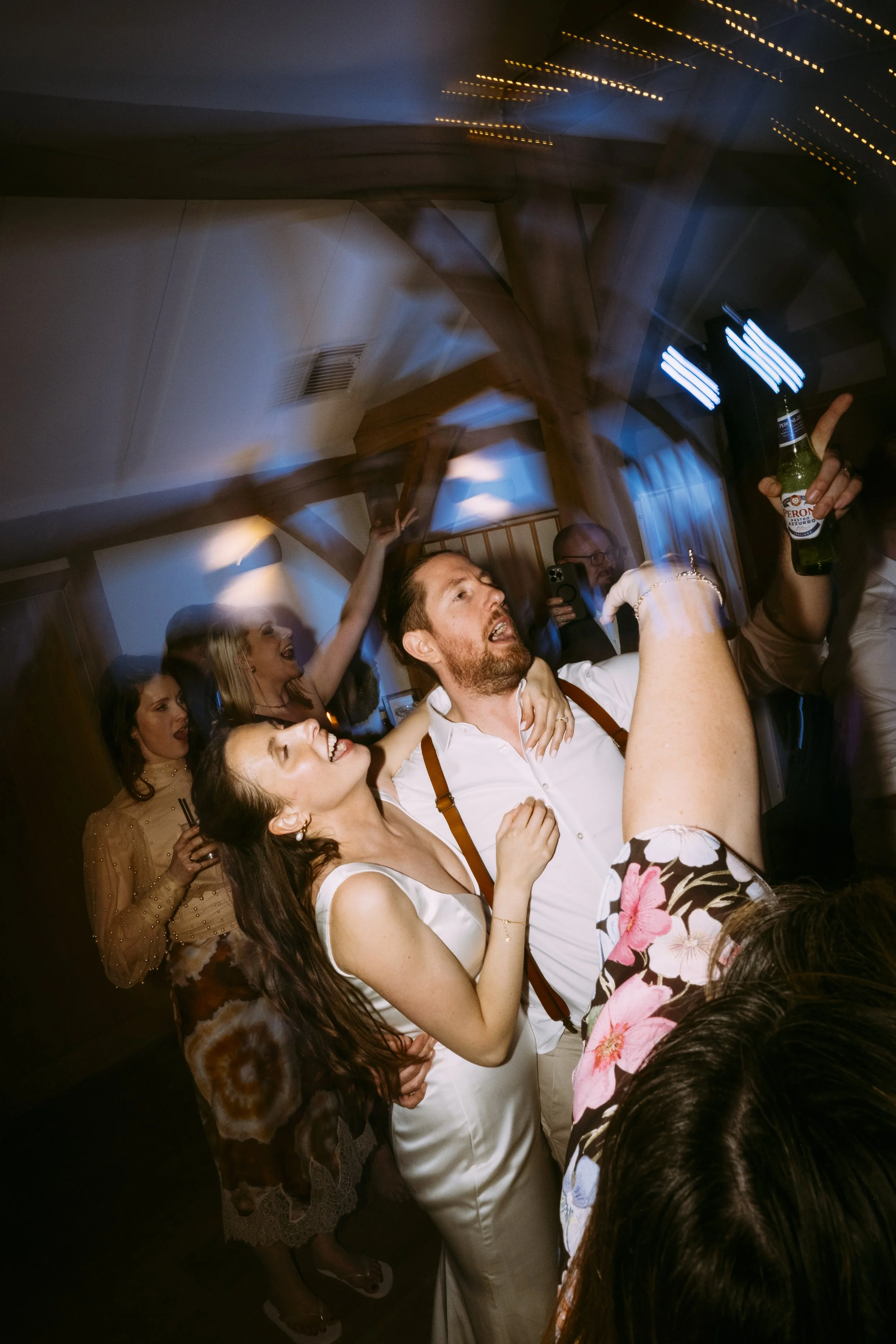 Bride and groom on a busy dance floor