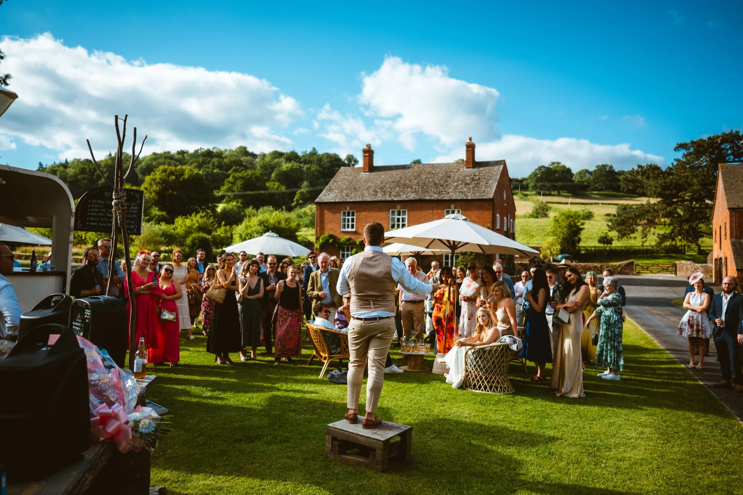 Groom giving a speech outside at The Haybarn