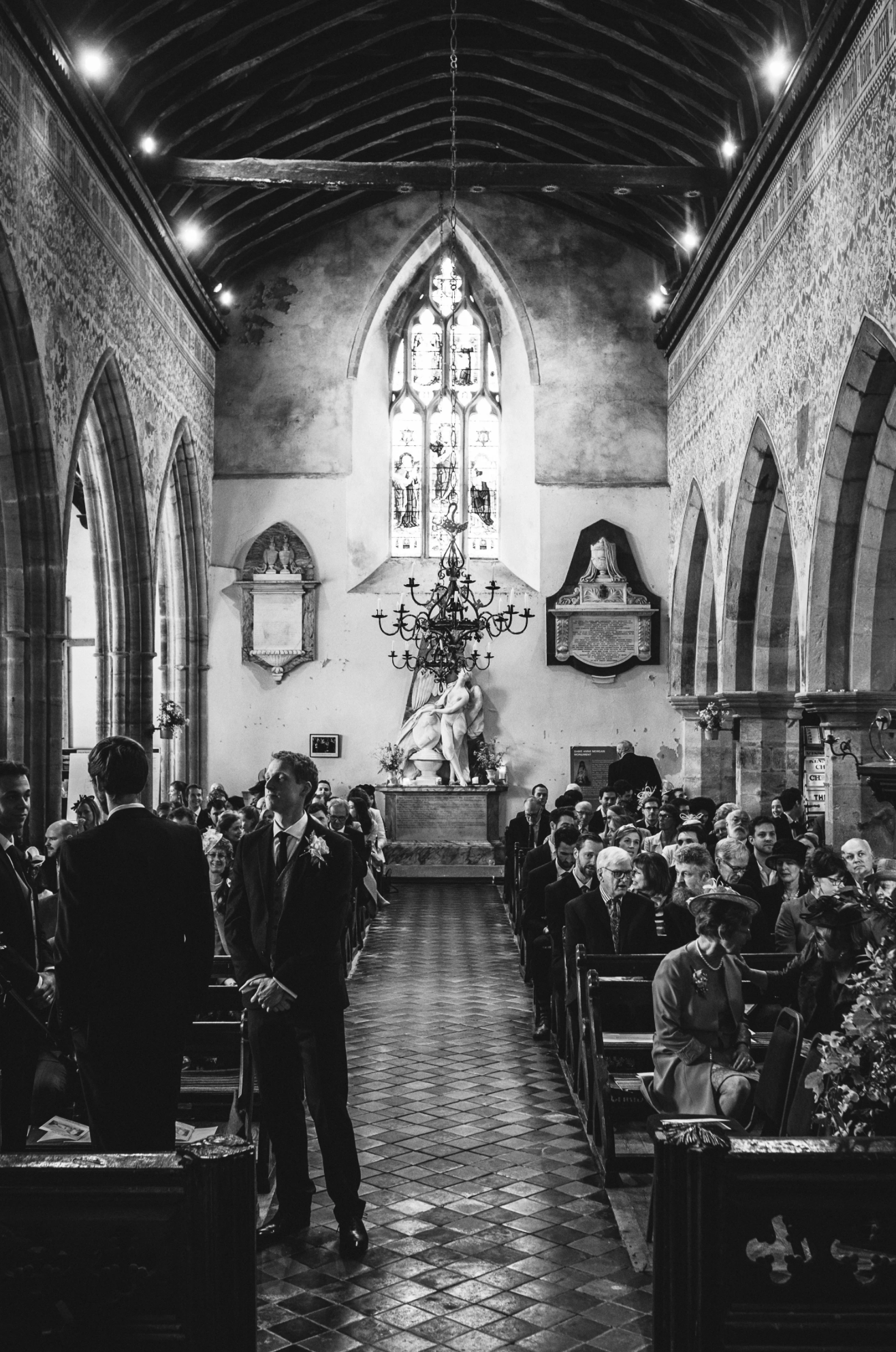 Groom waiting inside a Herefordshire church before the wedding ceremony