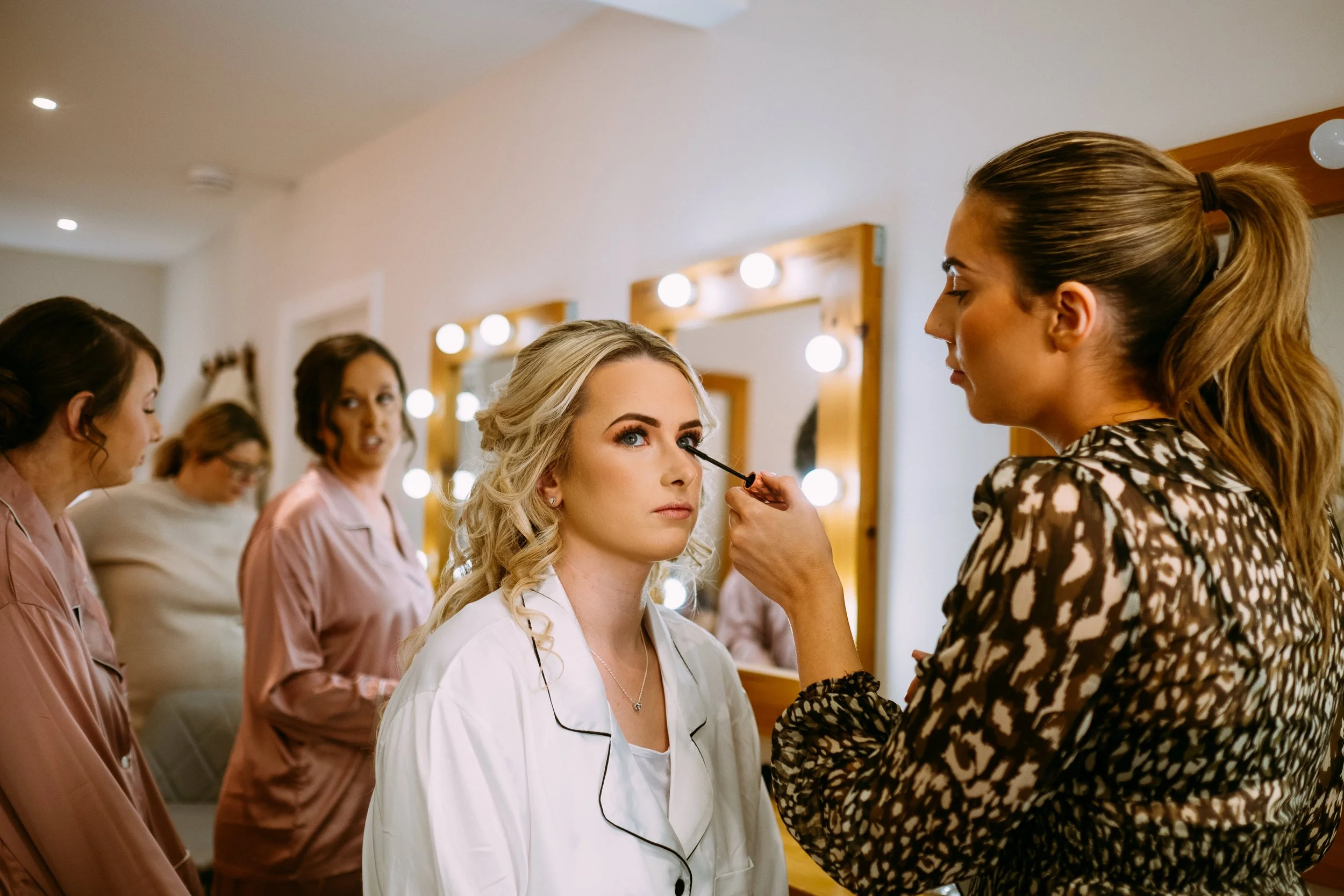 Bride getting her makeup done on her wedding day