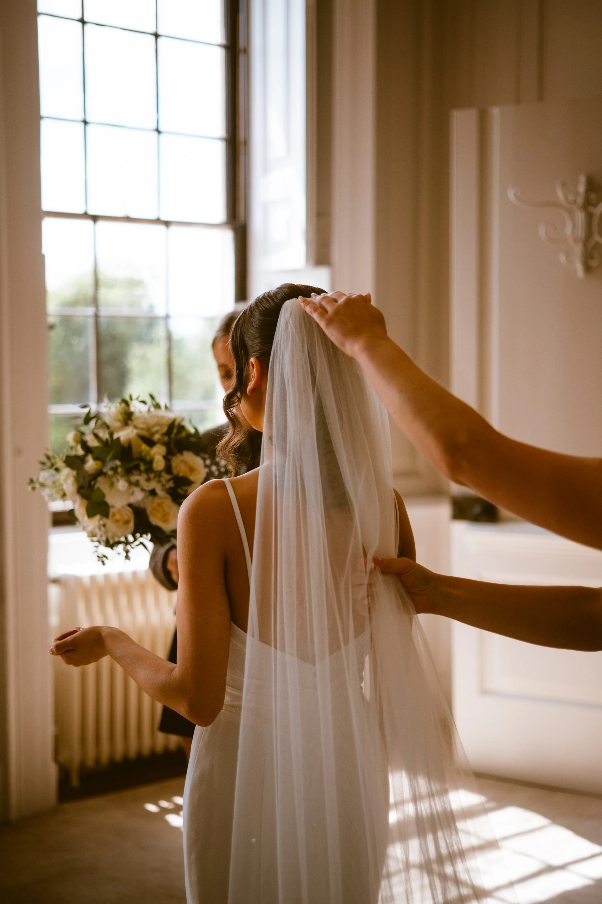 Bride having her veil fitted while getting ready for her wedding at Davenport House