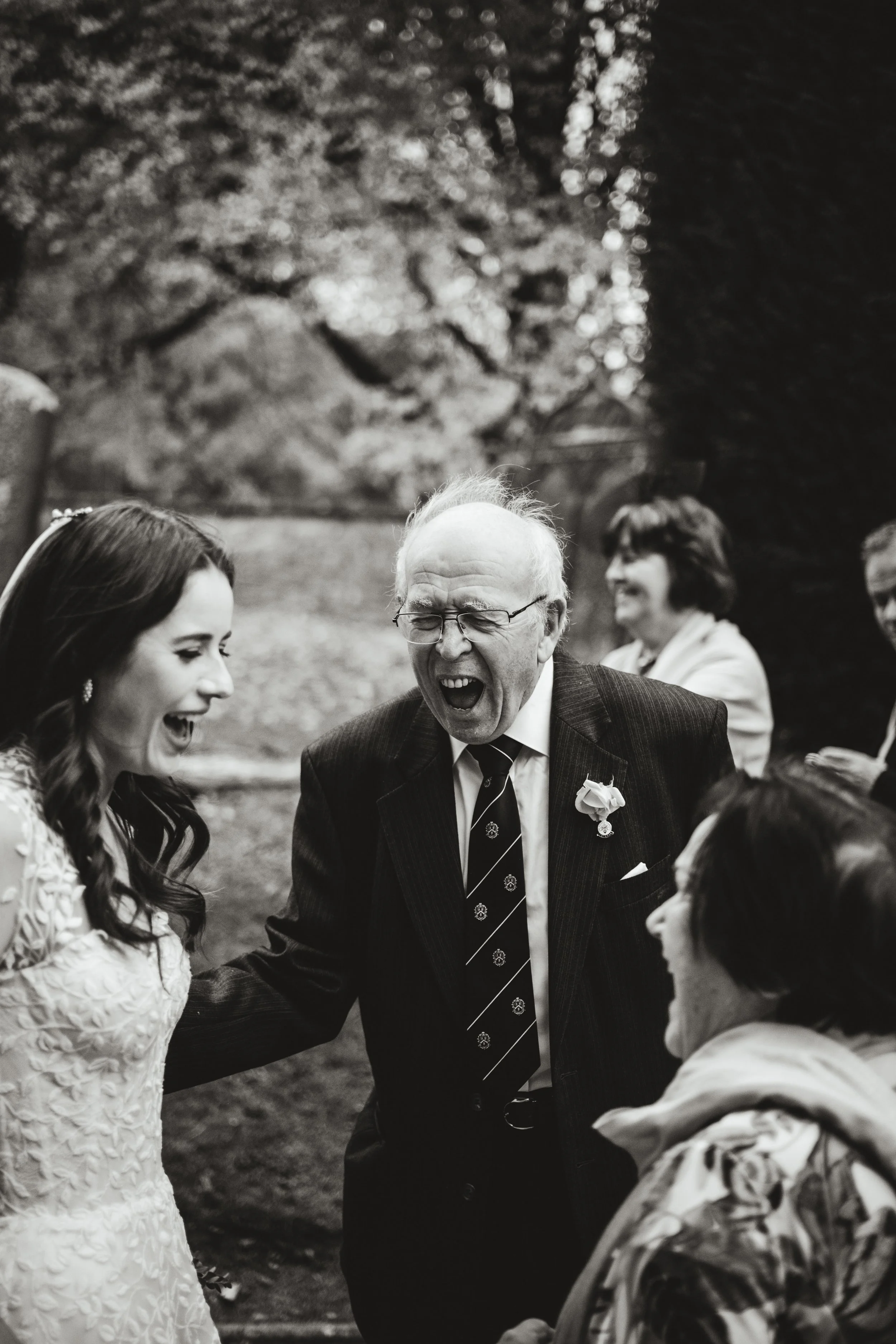 Grandad laughing with the bride on her wedding day